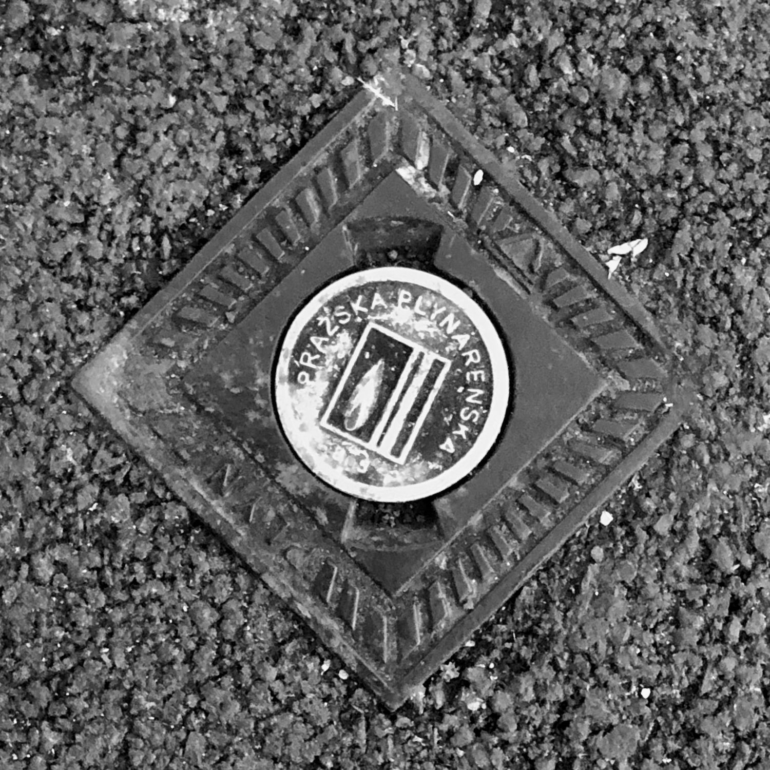 black and white image of a utility cover