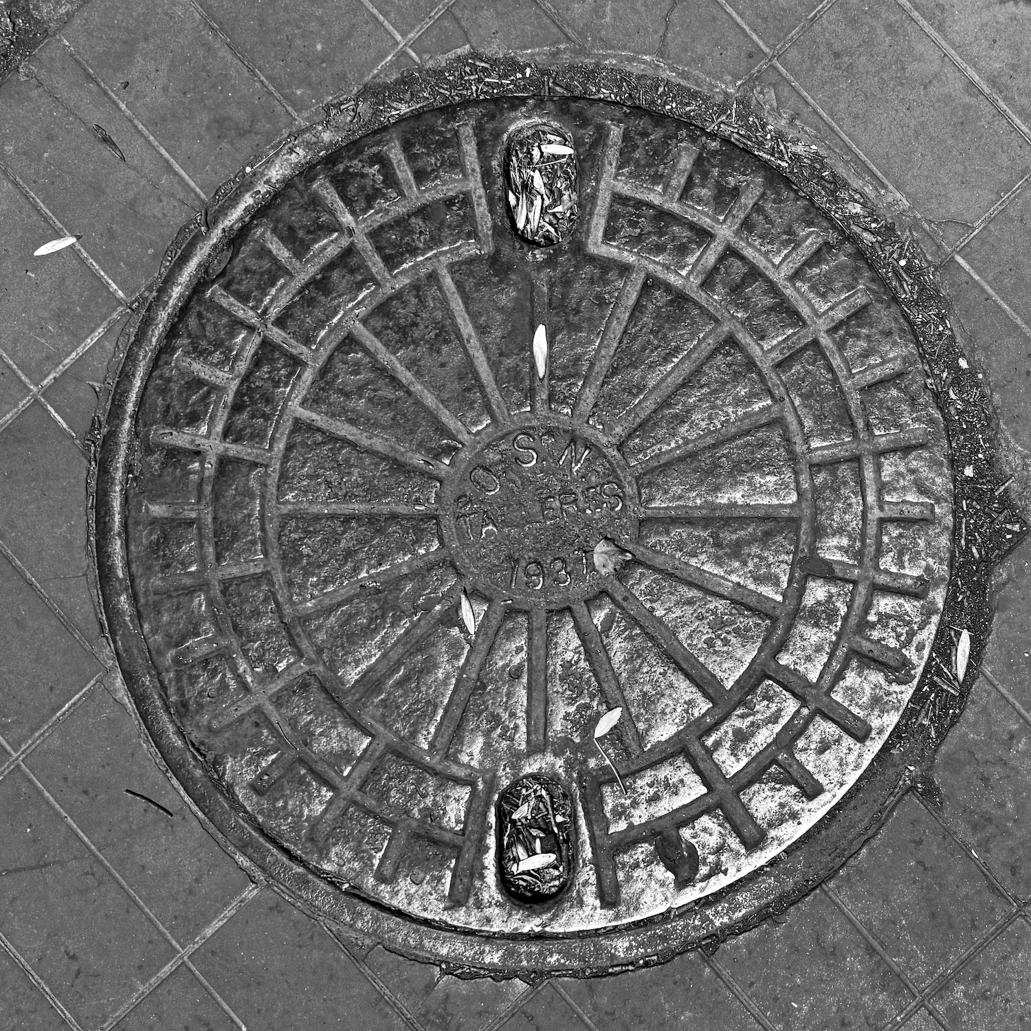 black and white image of a utility cover