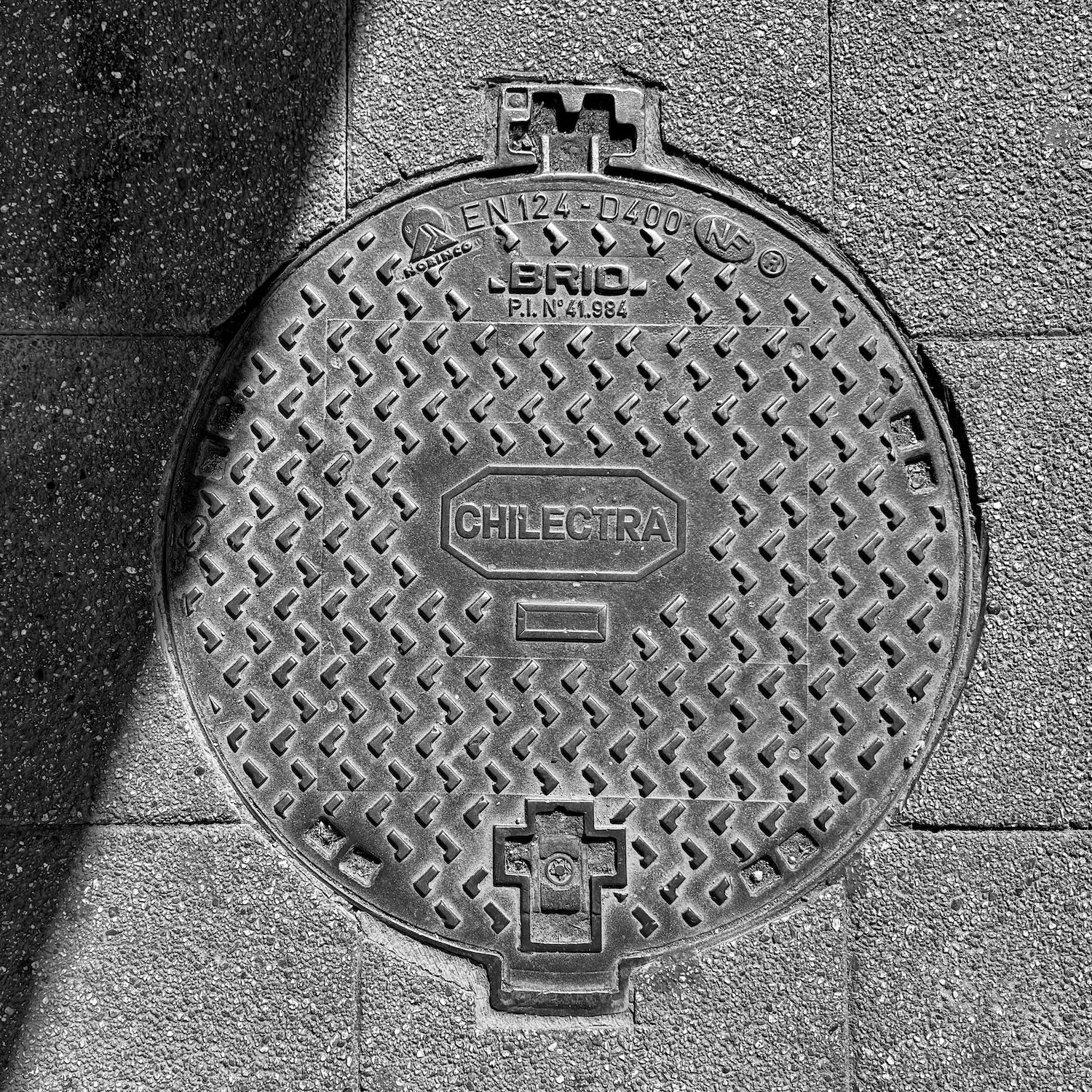 black and white image of a utility cover