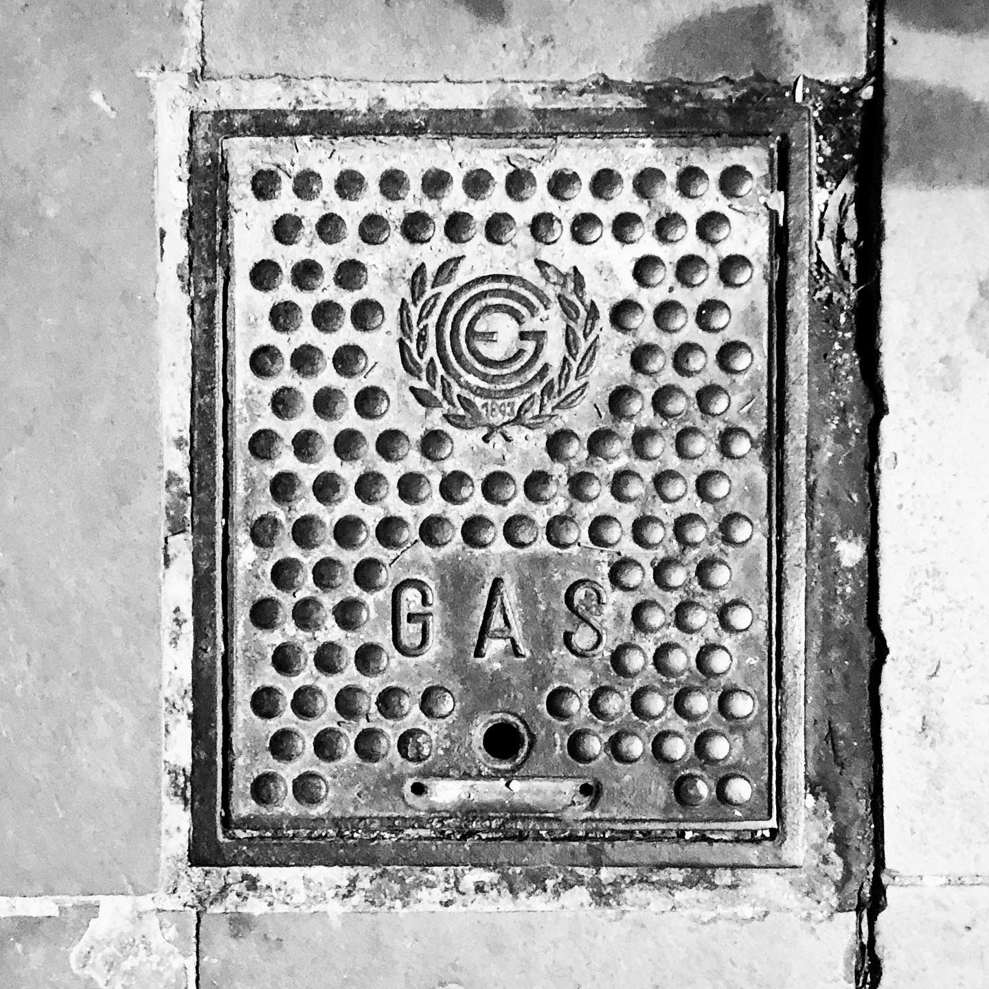 black and white image of a utility cover