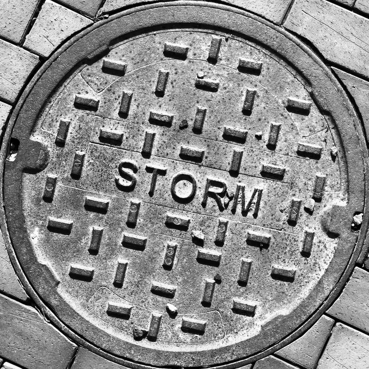 black and white image of a utility cover