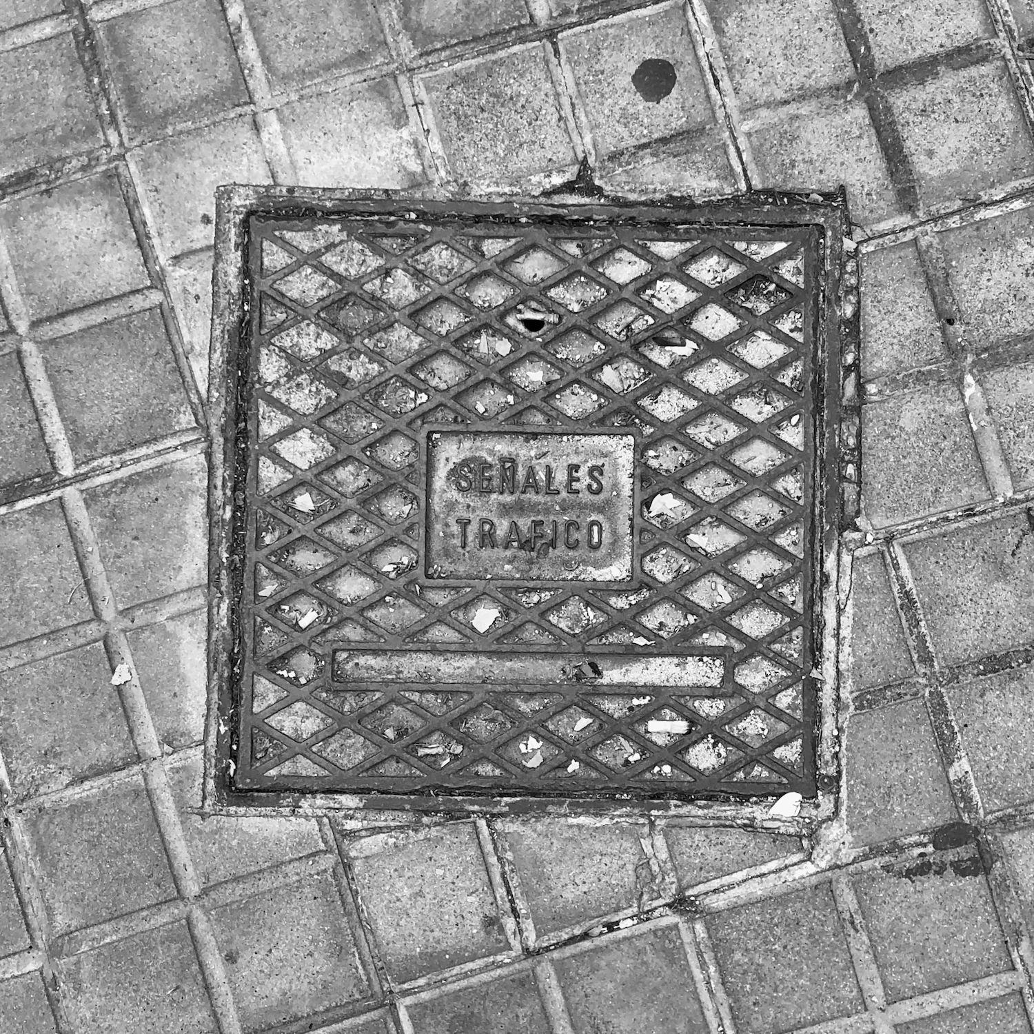 black and white image of a utility cover