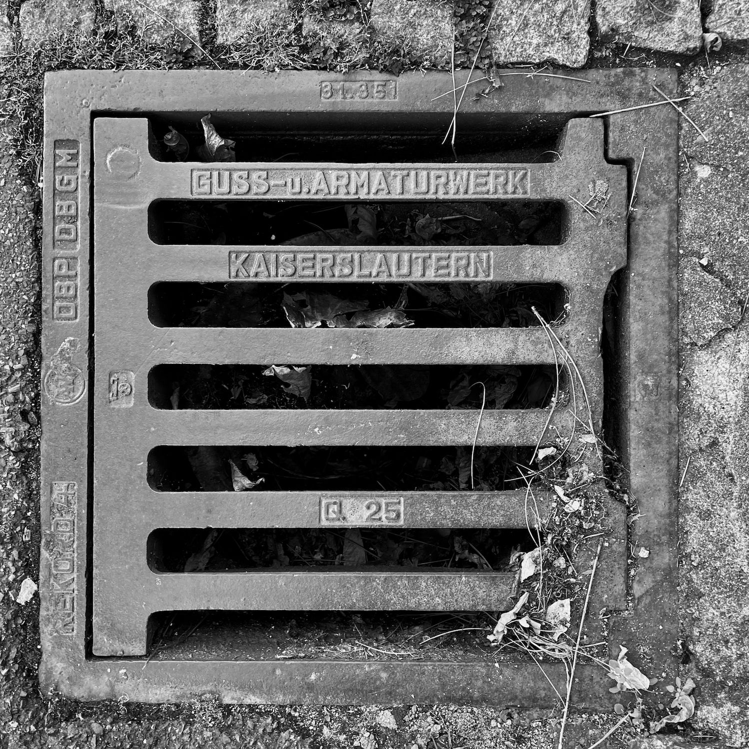 black and white image of a utility cover