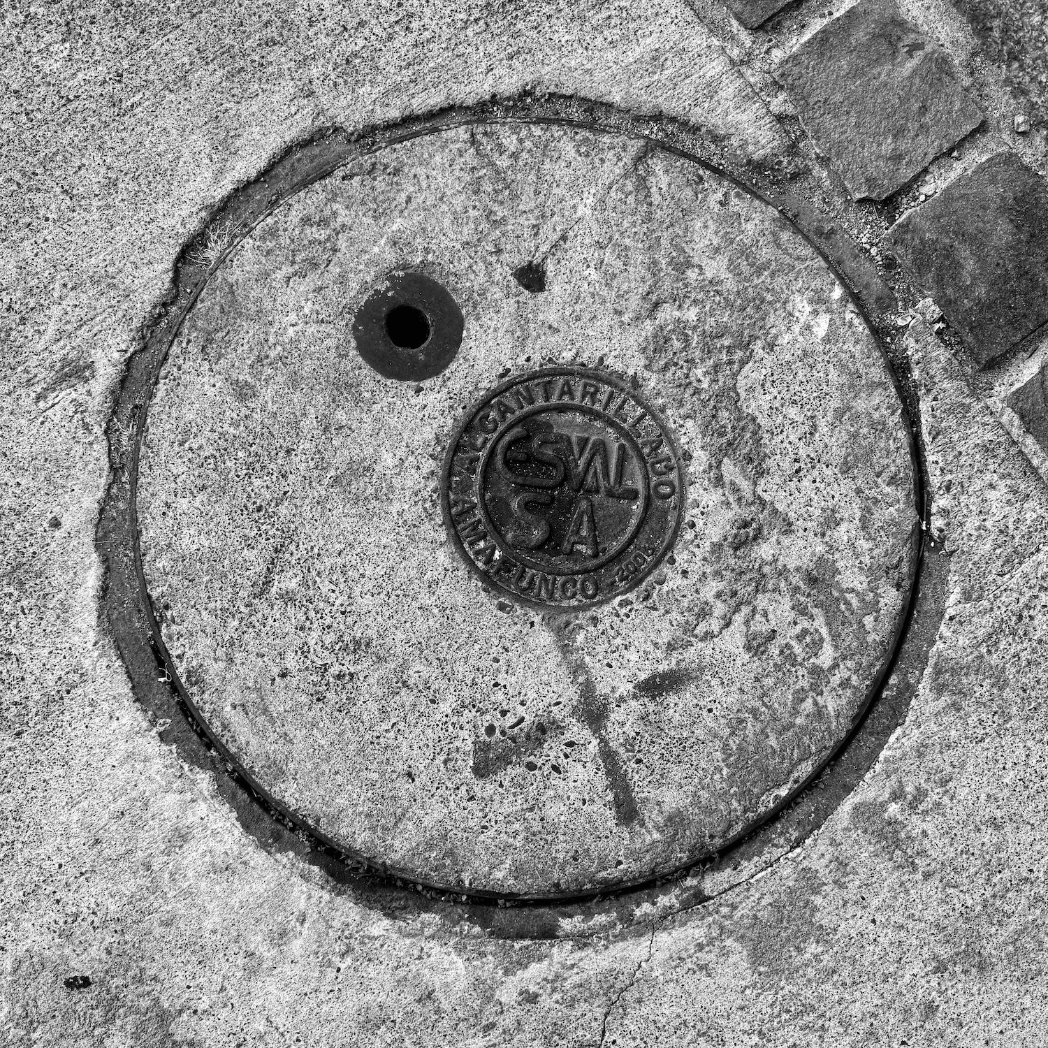 black and white image of a utility cover