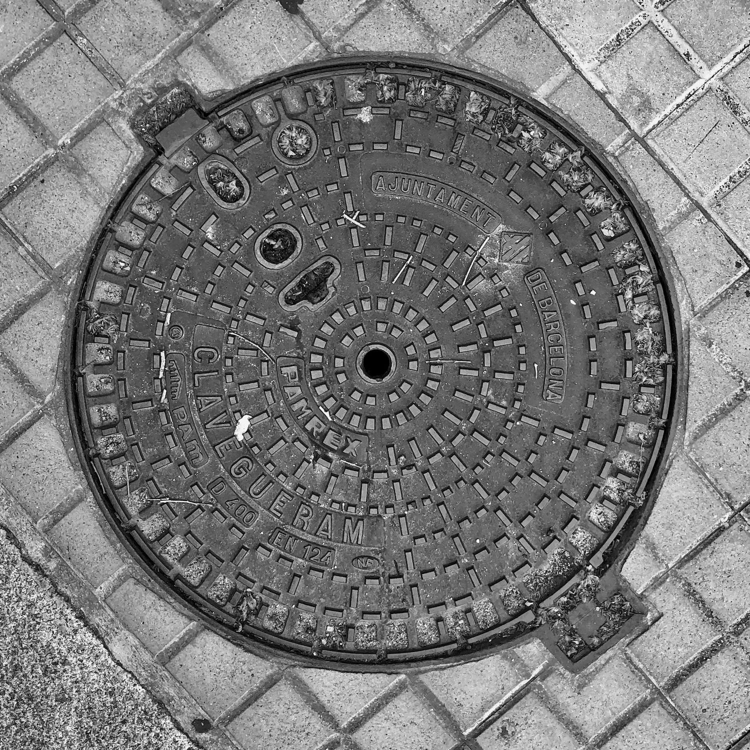 black and white image of a utility cover