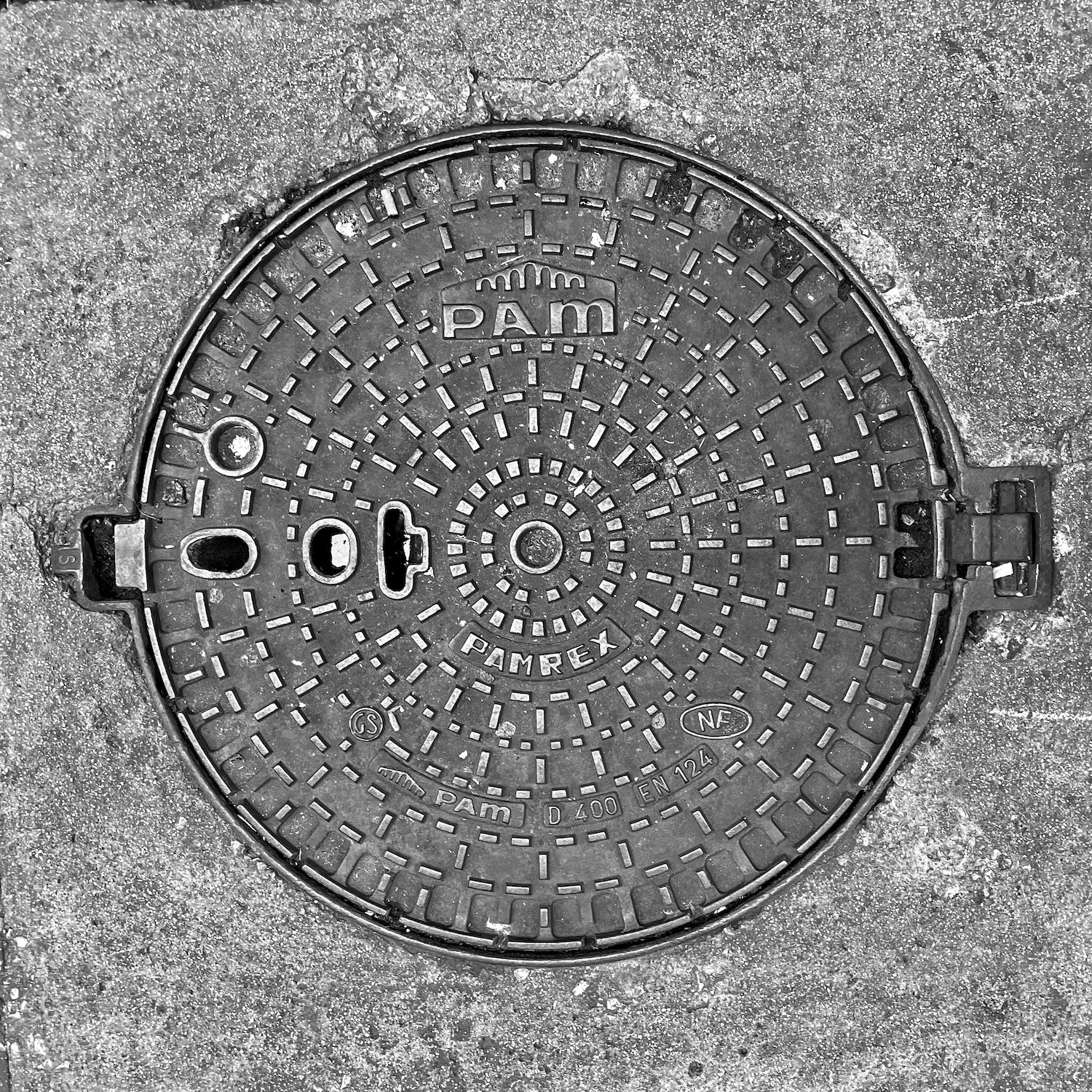 black and white image of a utility cover