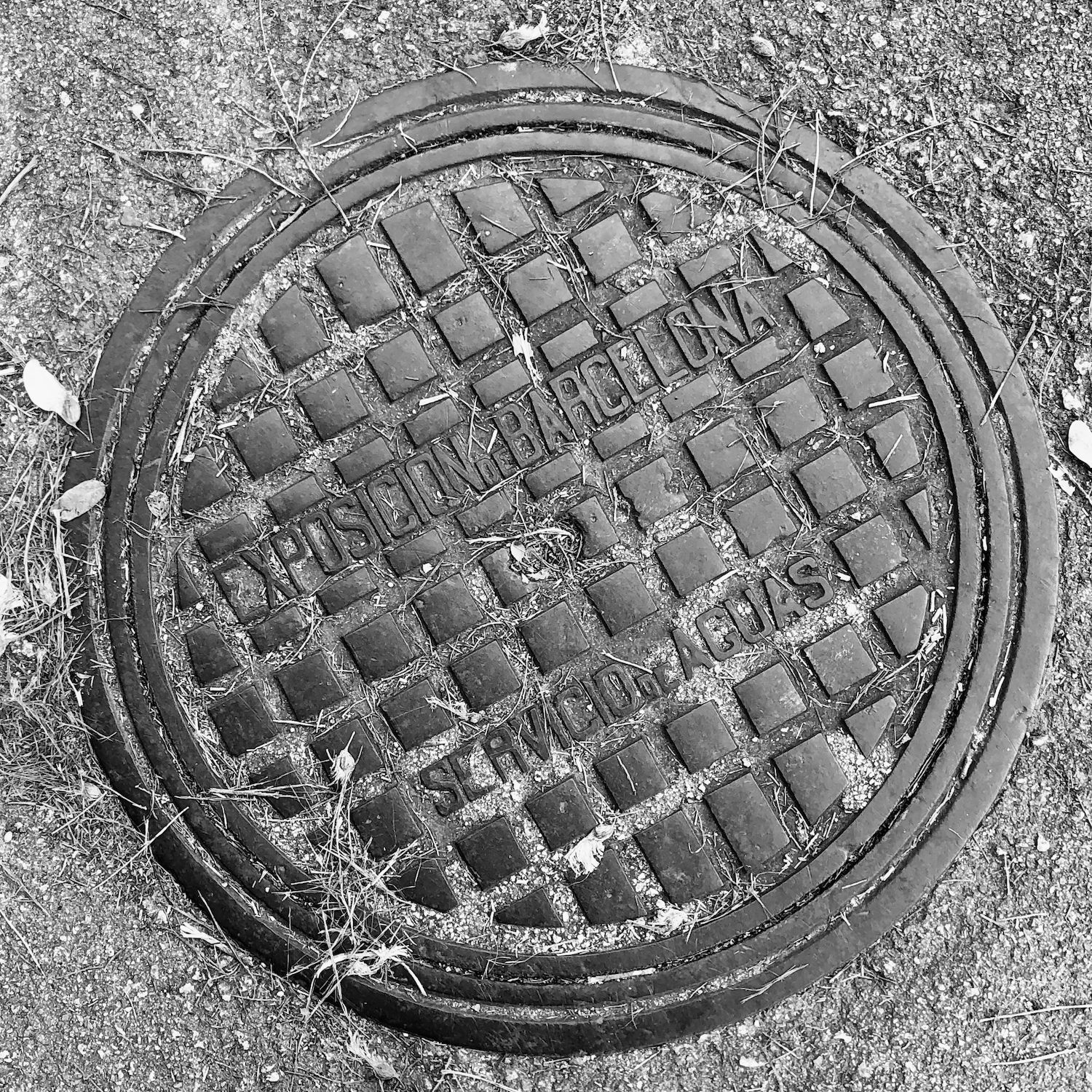black and white image of a utility cover