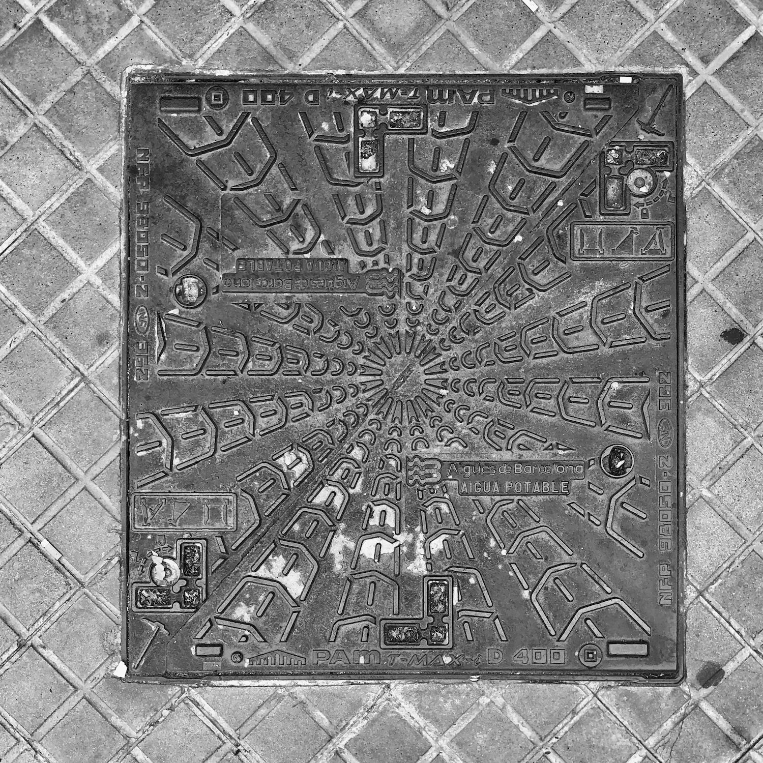 black and white image of a utility cover