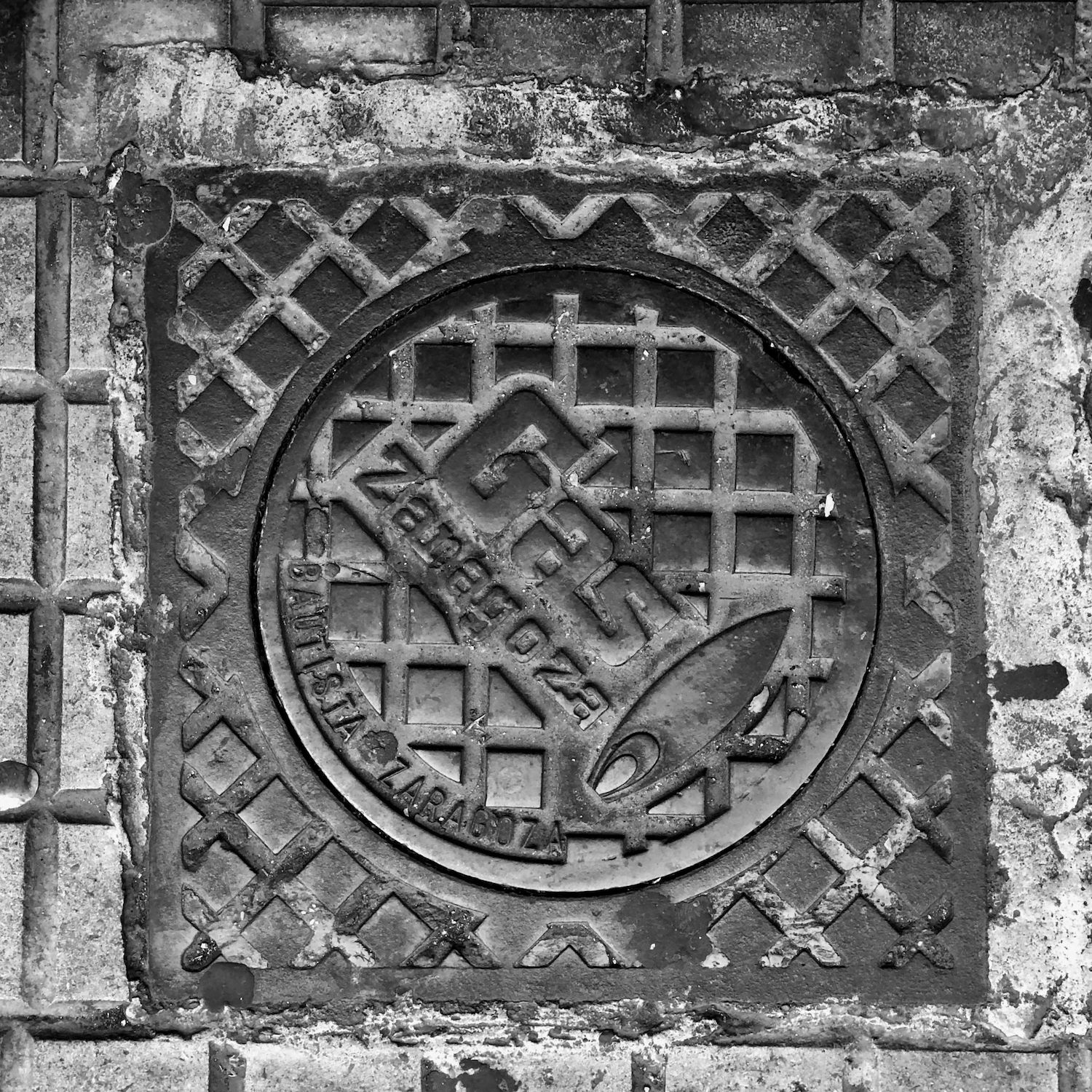 black and white image of a utility cover