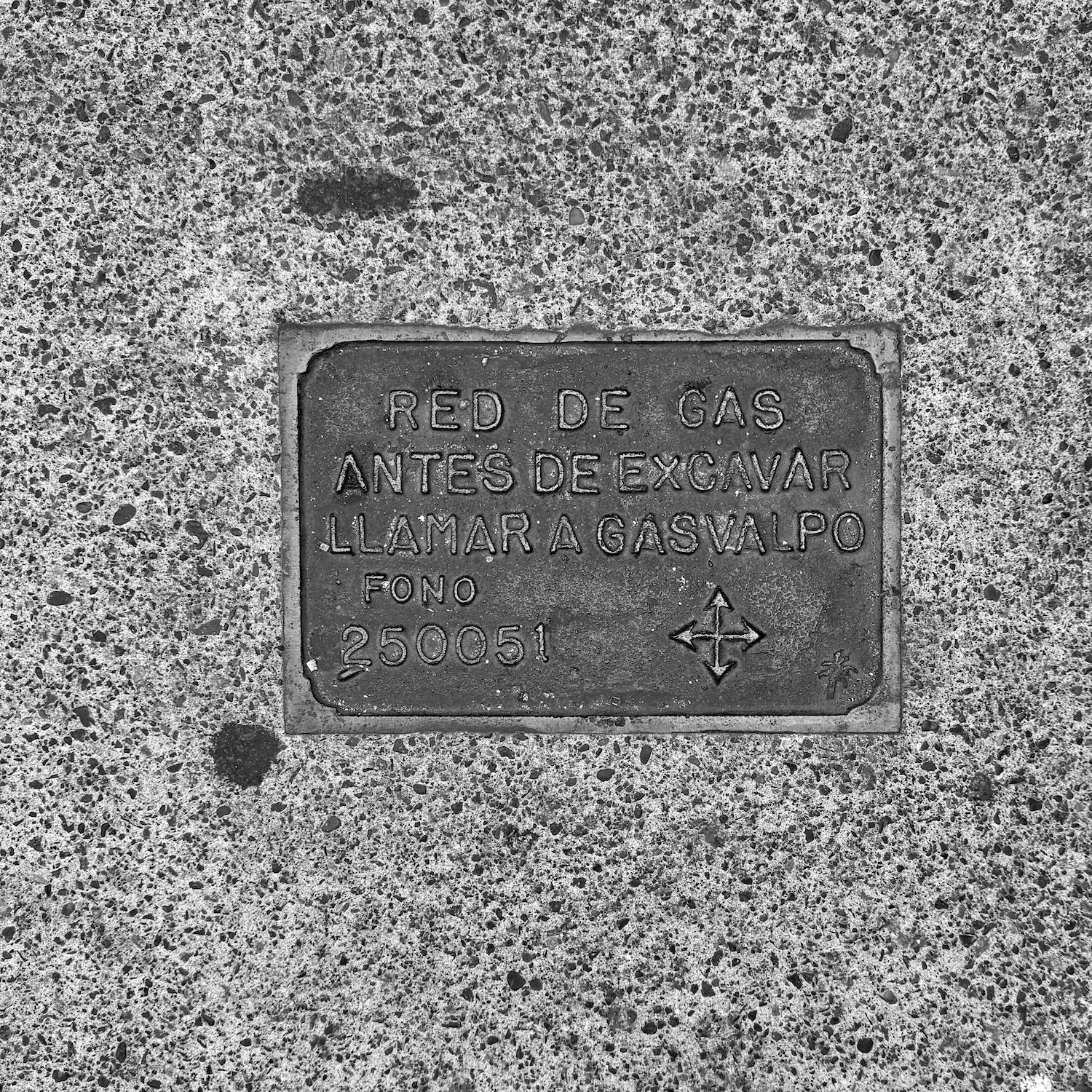 black and white image of a utility cover
