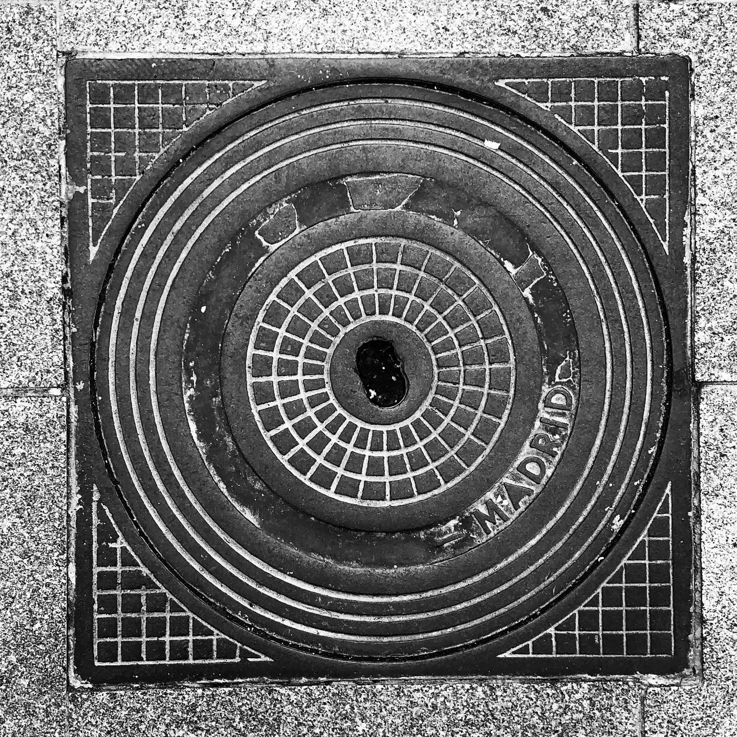 black and white image of a utility cover