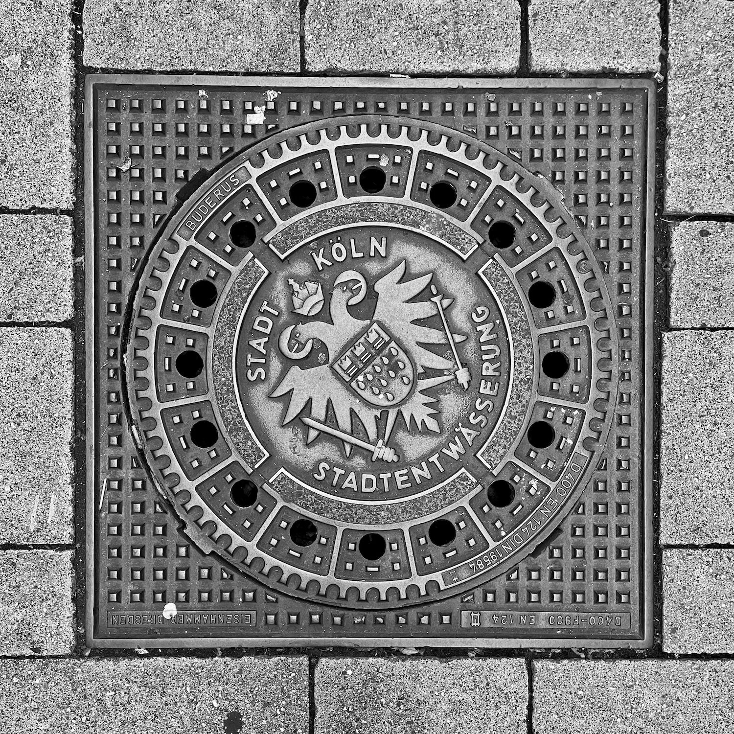 black and white image of a utility cover
