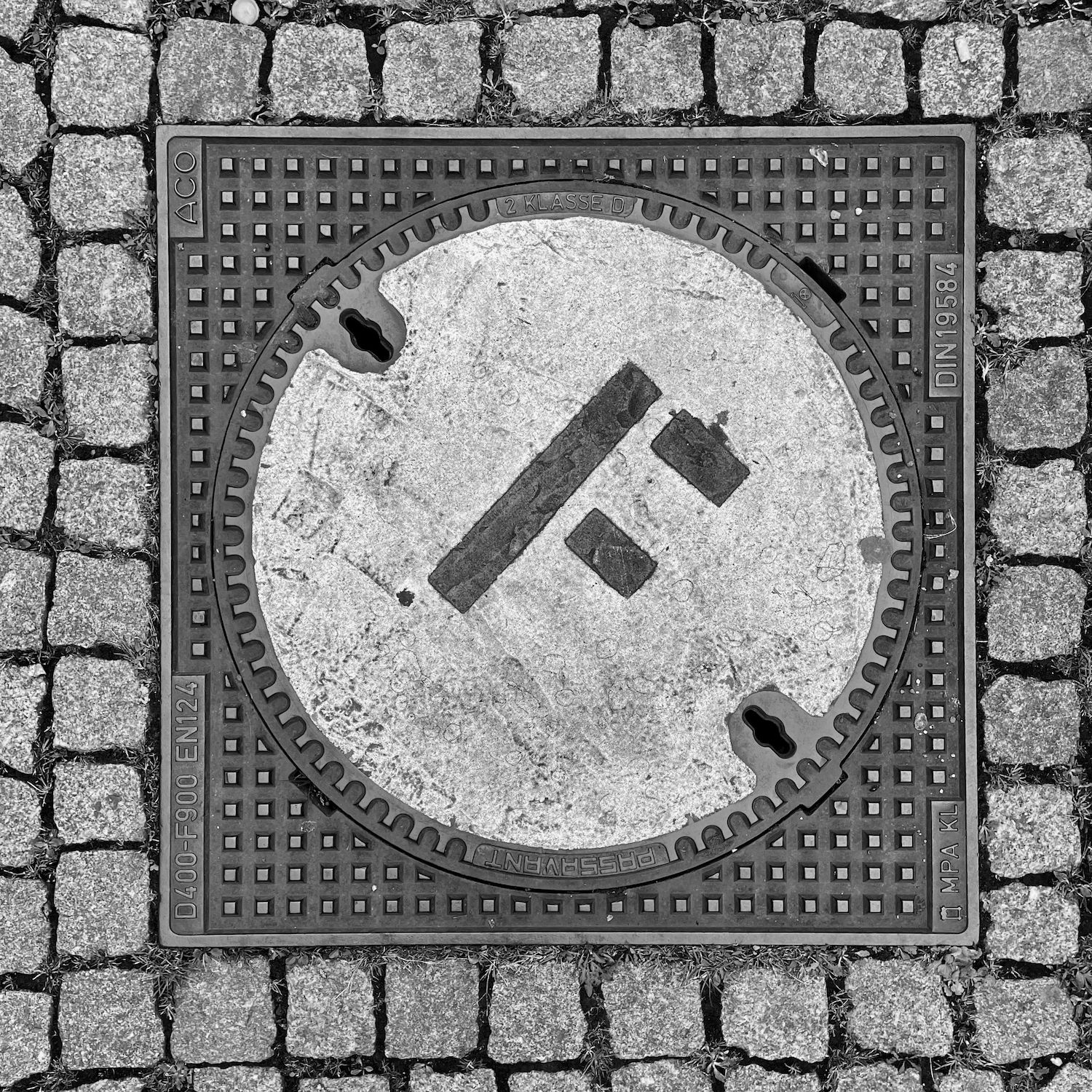 black and white image of a utility cover