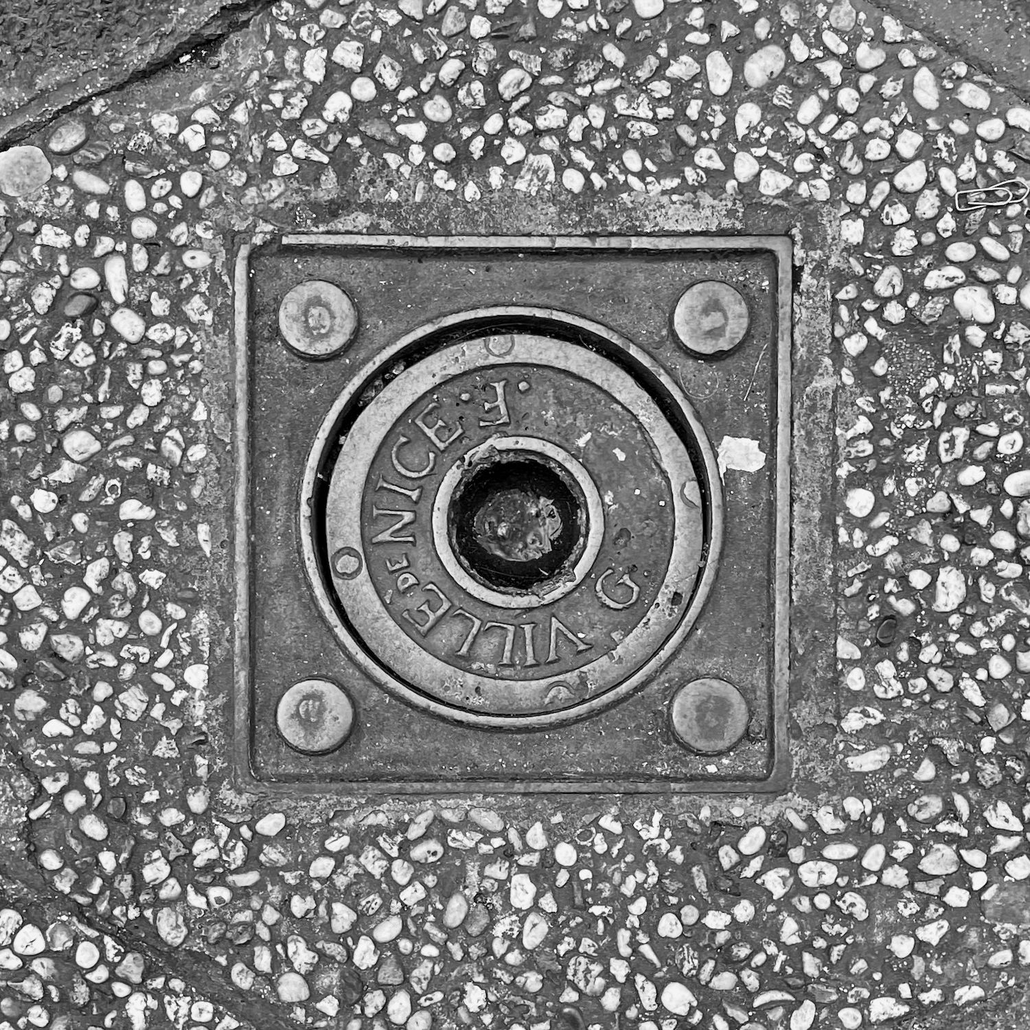 black and white image of a utility cover