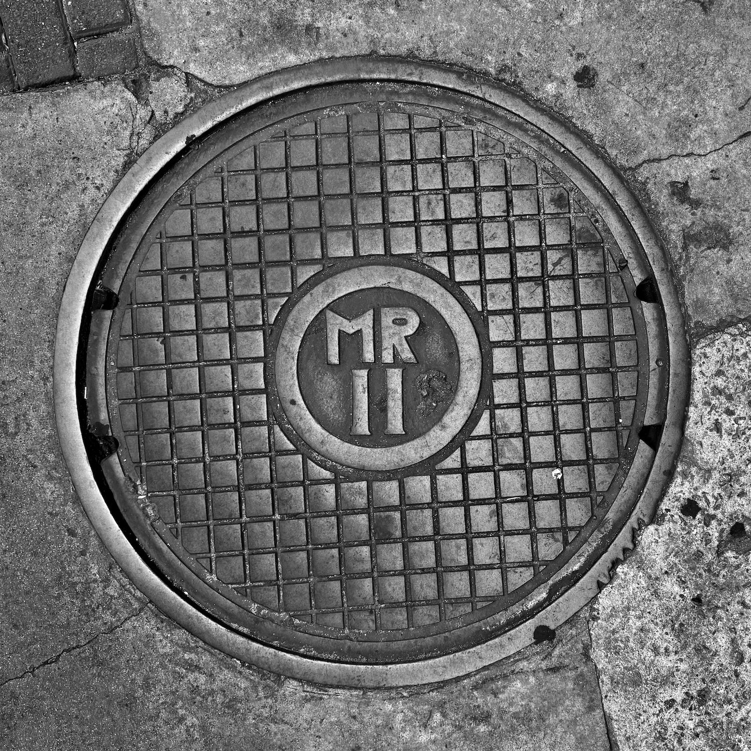 black and white image of a utility cover