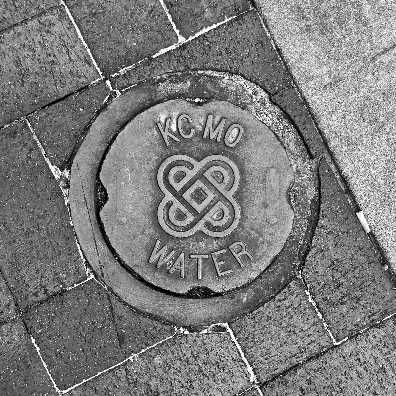 black and white image of a utility cover