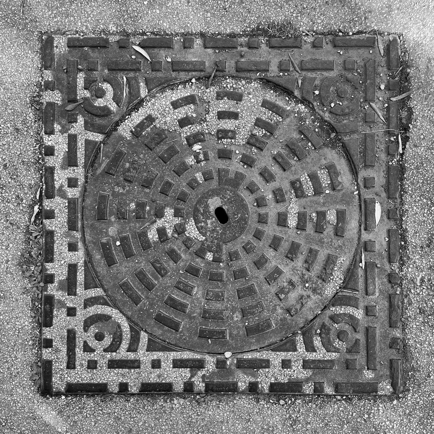 black and white image of a utility cover