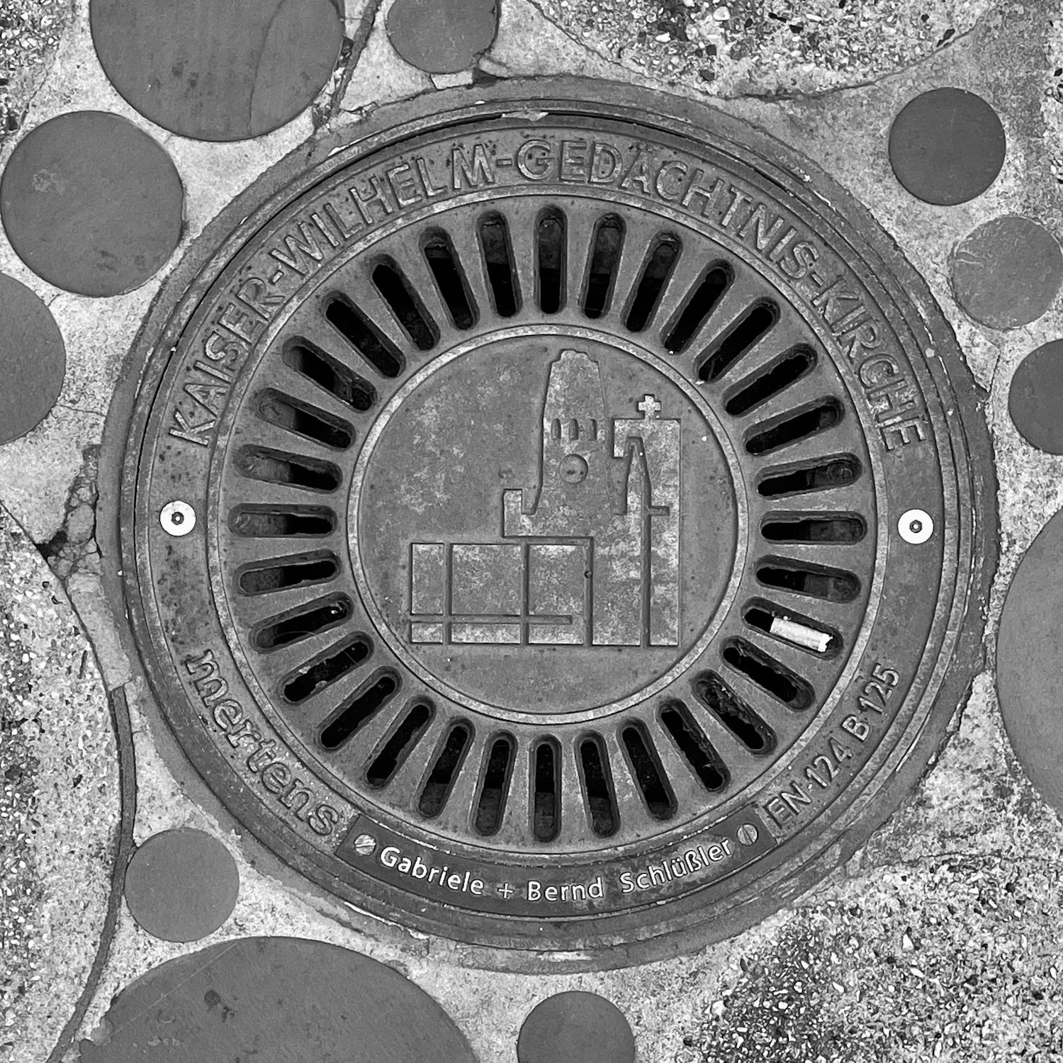 black and white image of a utility cover