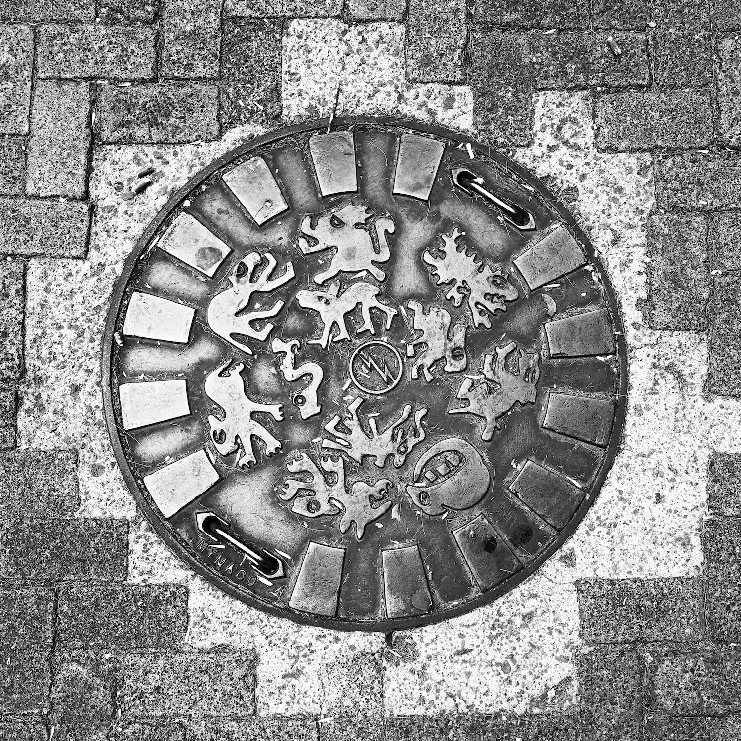 black and white image of a utility cover
