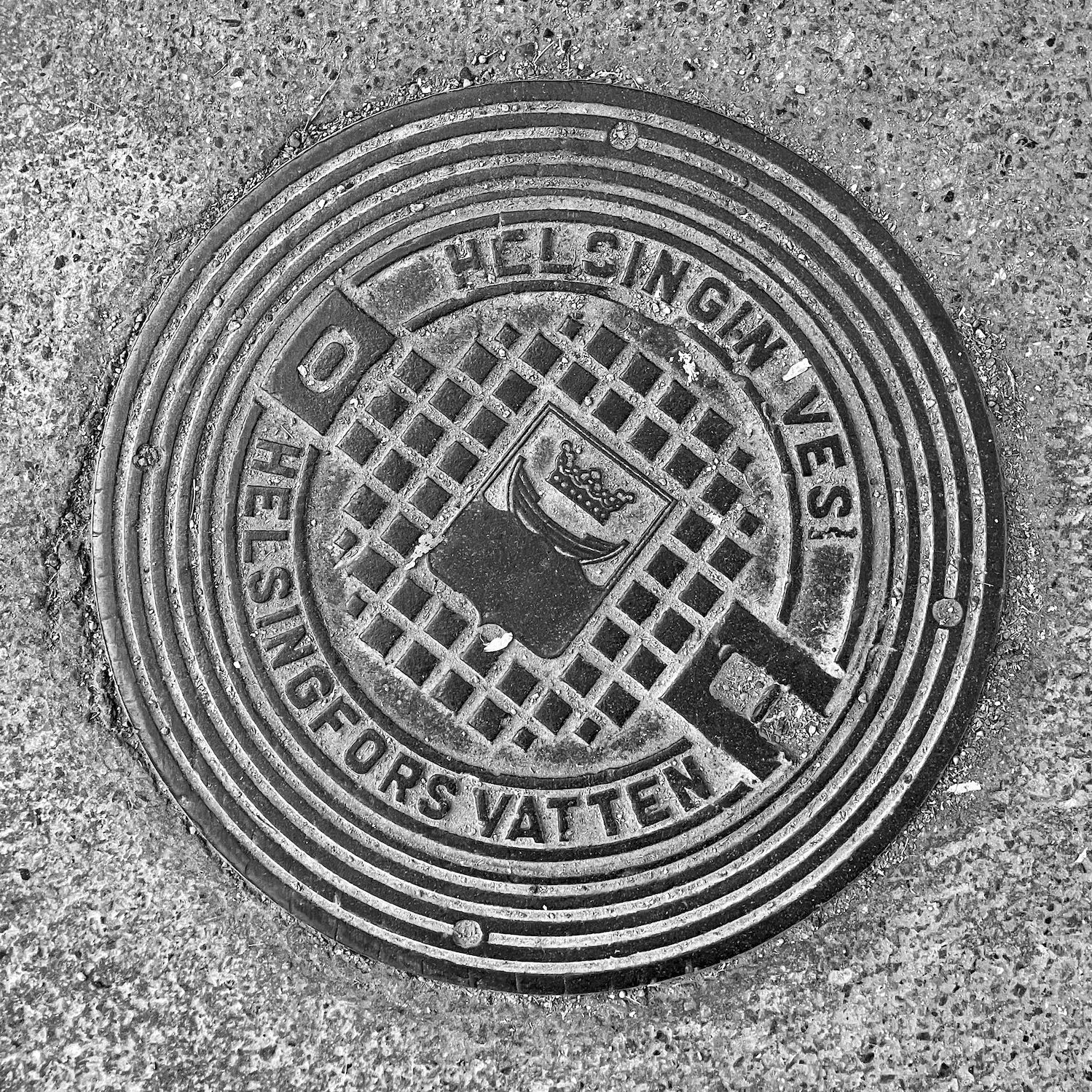 black and white image of a utility cover