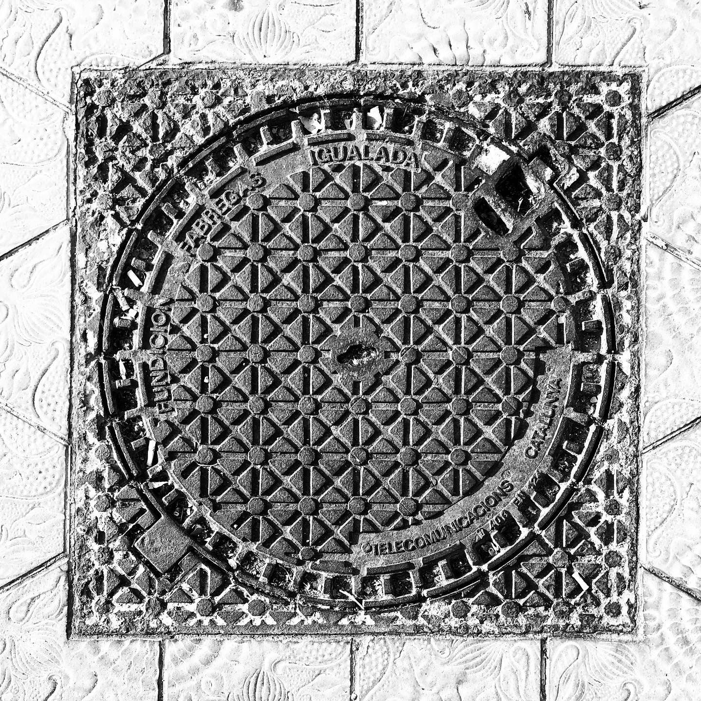 black and white image of a utility cover