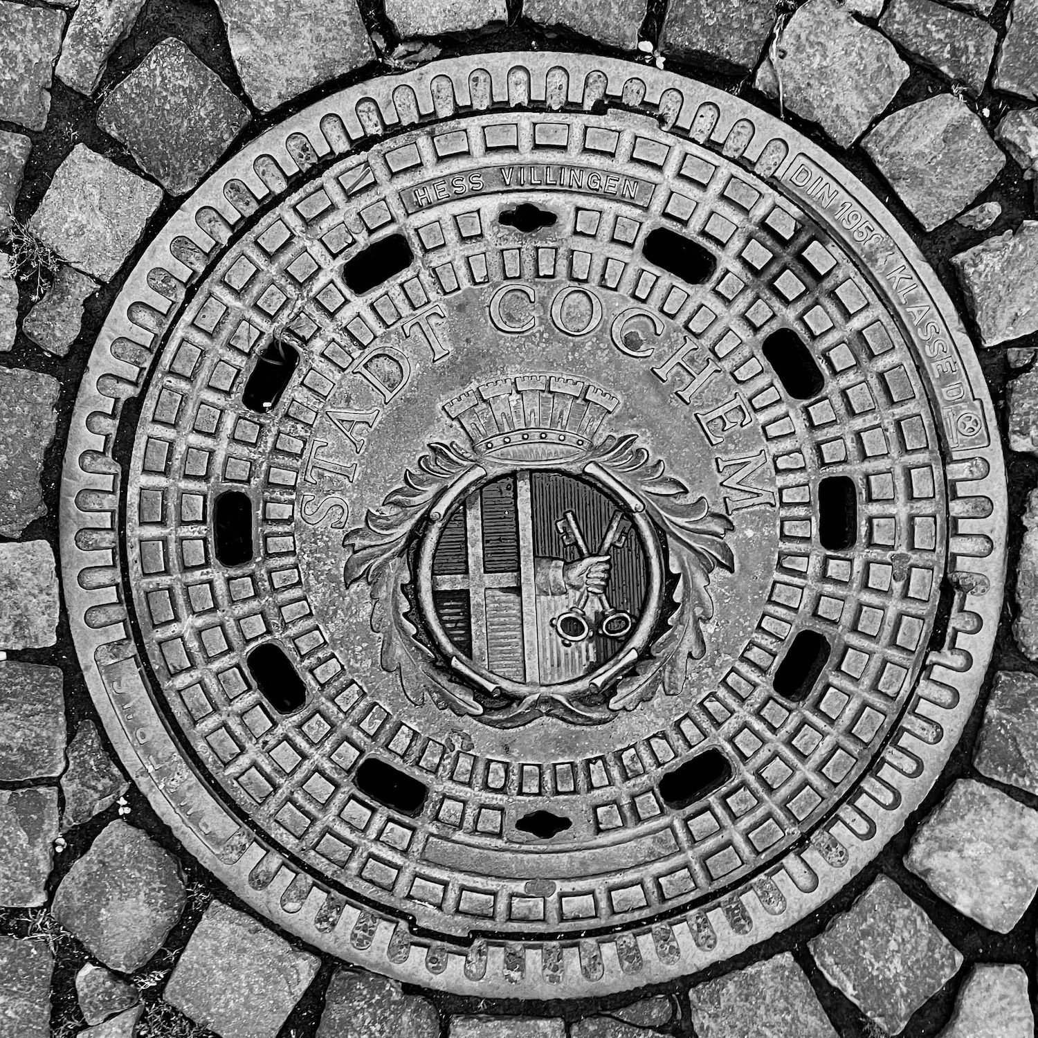 black and white image of a utility cover