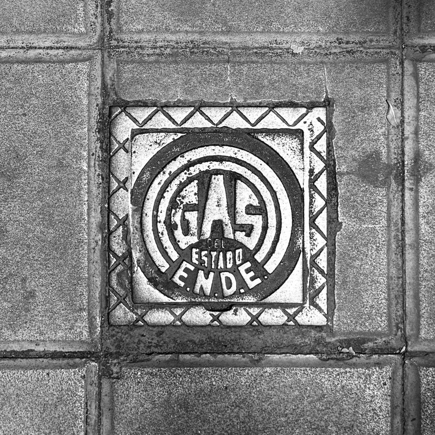 black and white image of a utility cover