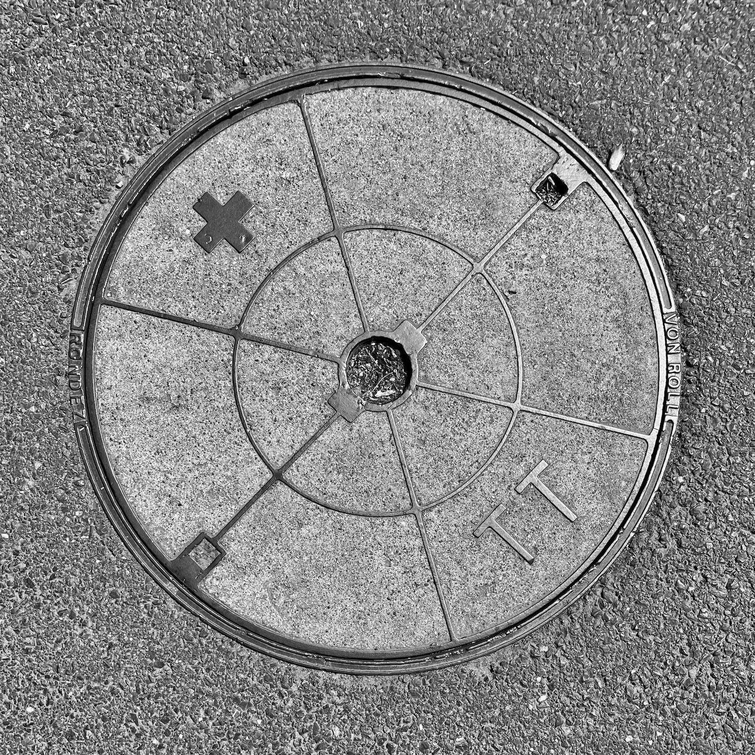 black and white image of a utility cover