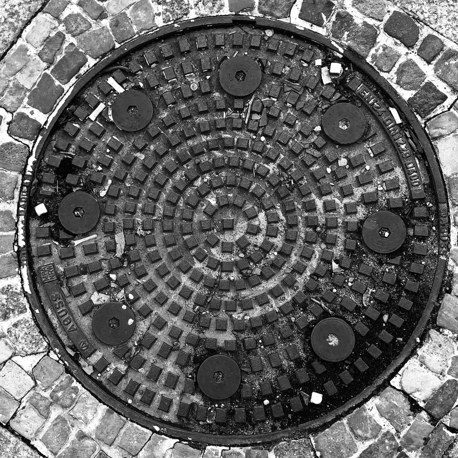 black and white image of a utility cover