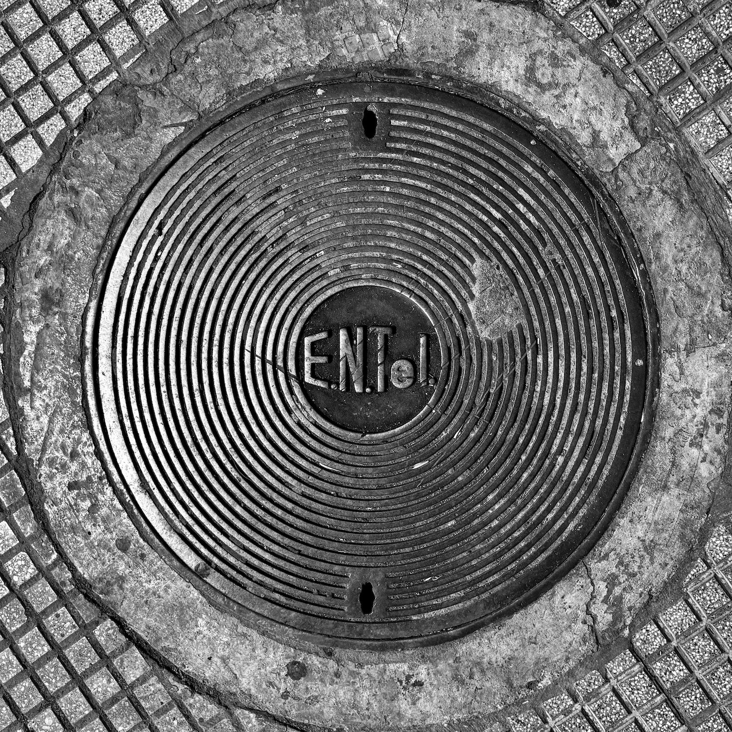 black and white image of a utility cover