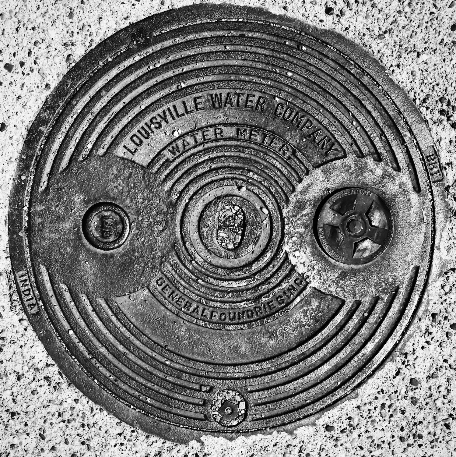 black and white image of a utility cover