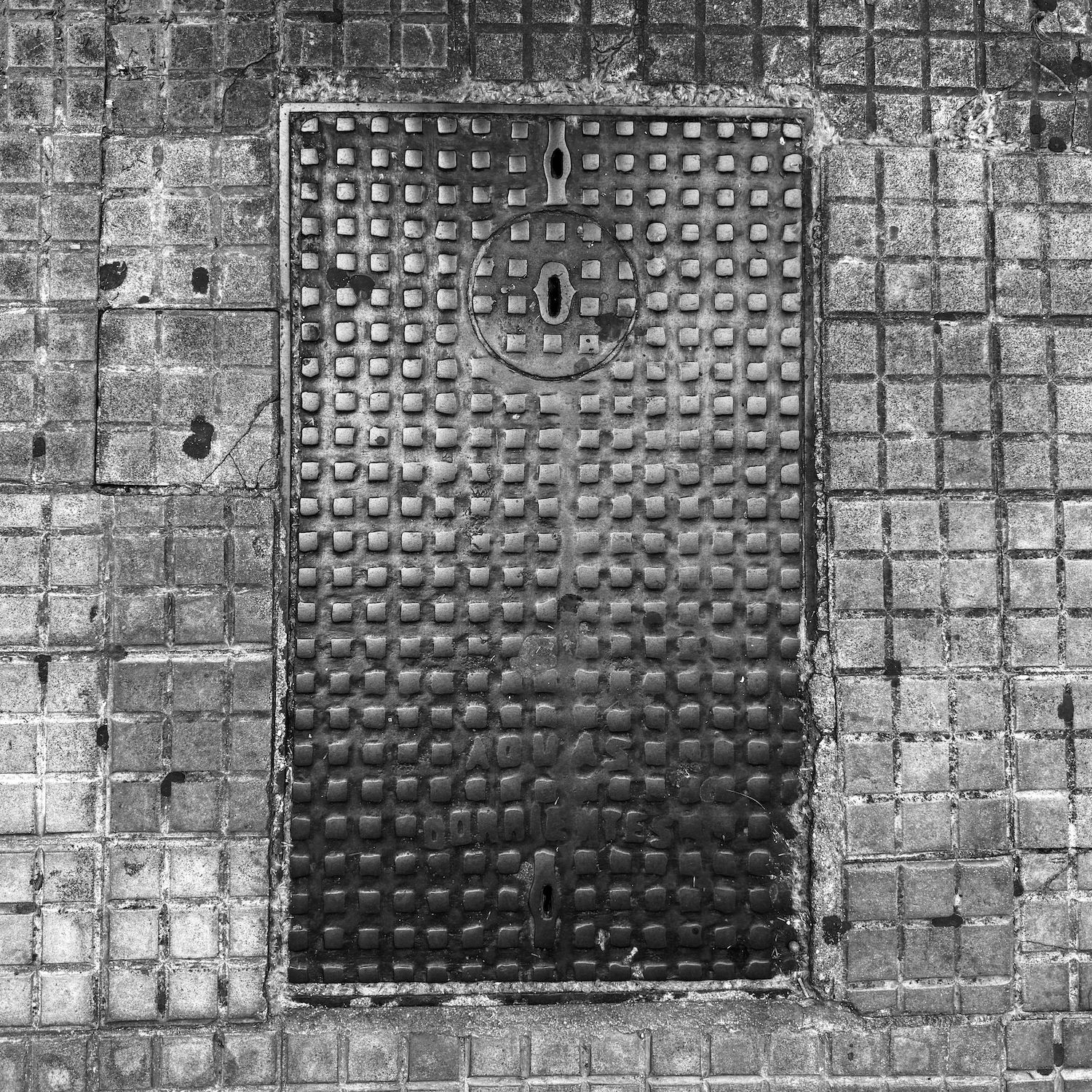 black and white image of a utility cover