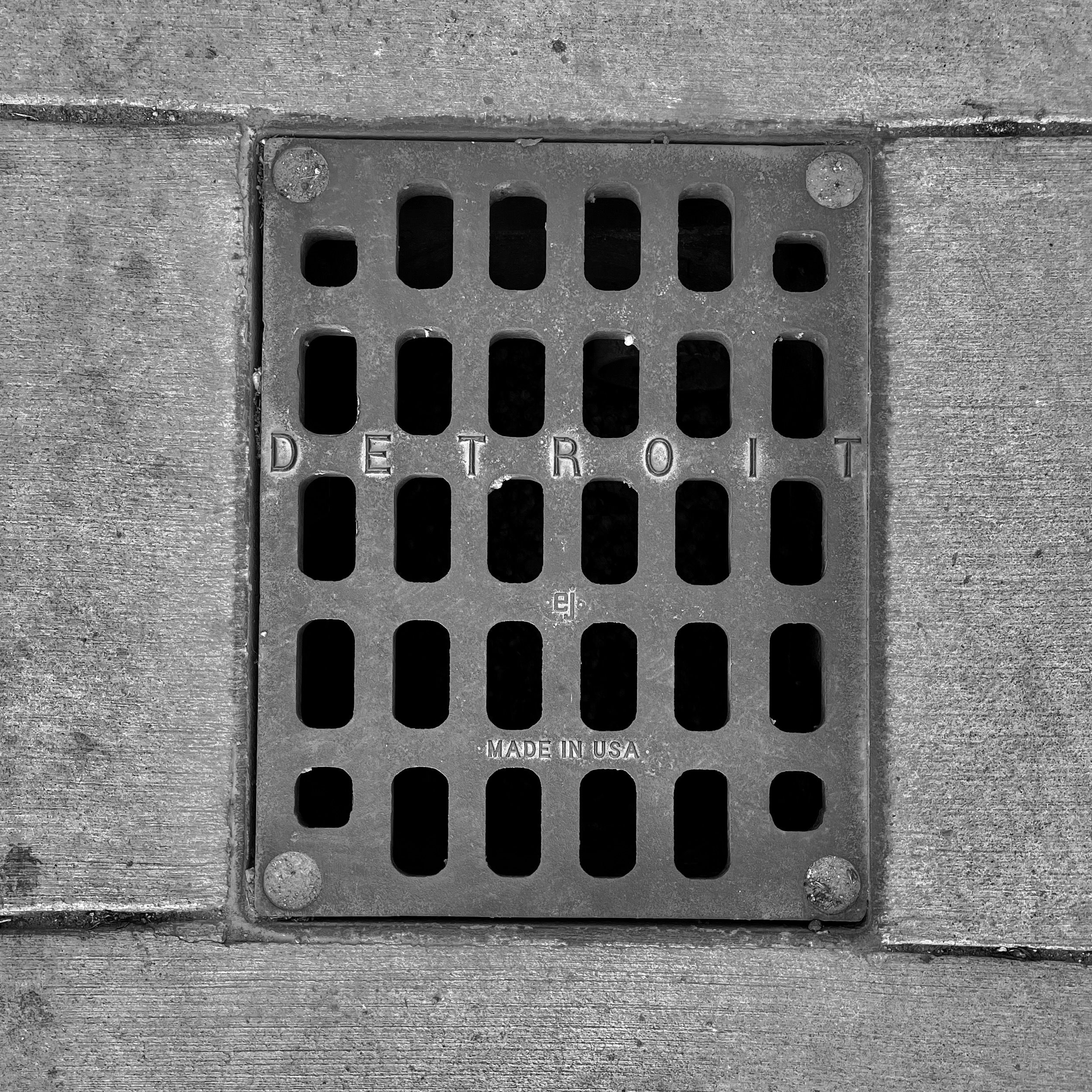 black and white image of a utility cover