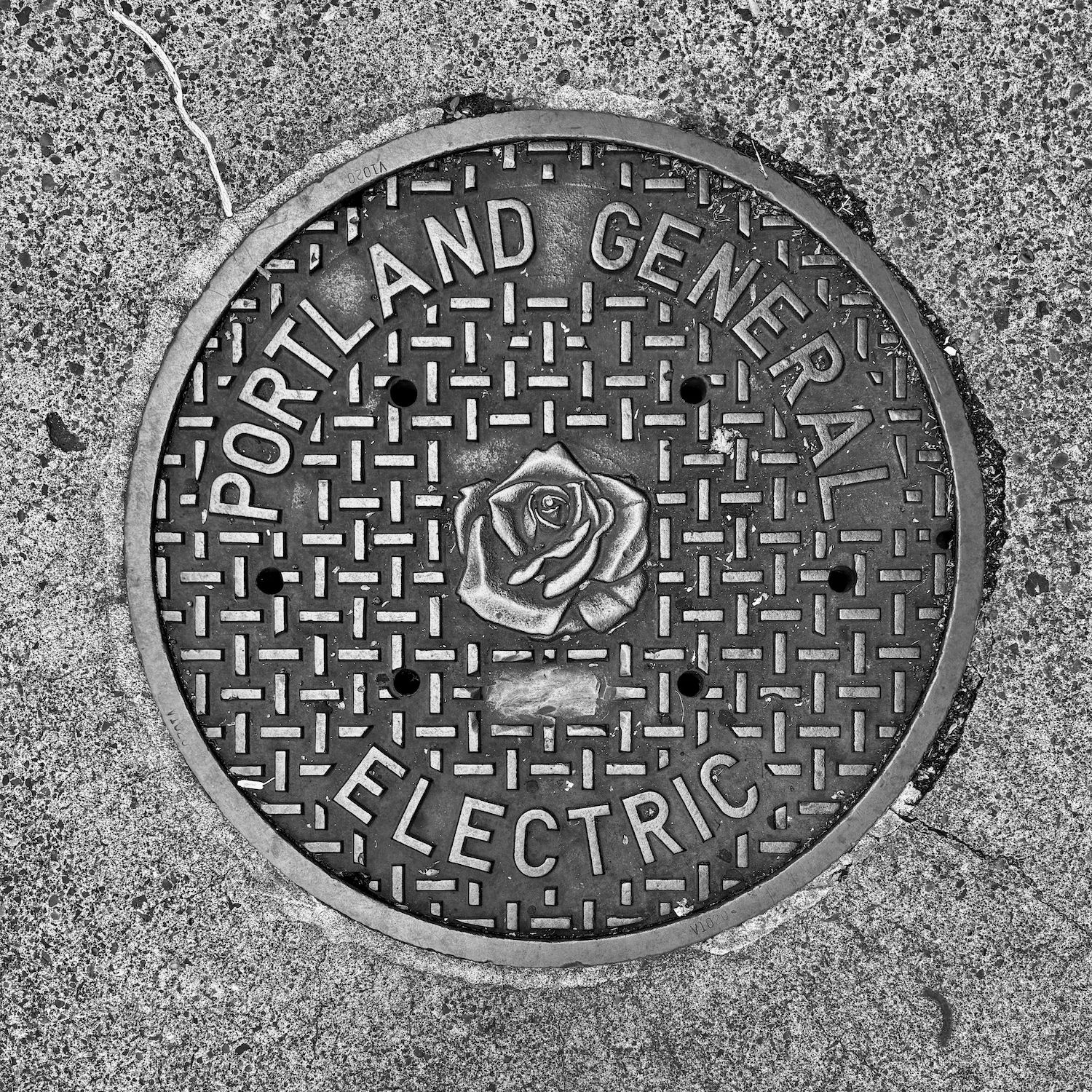 black and white image of a utility cover