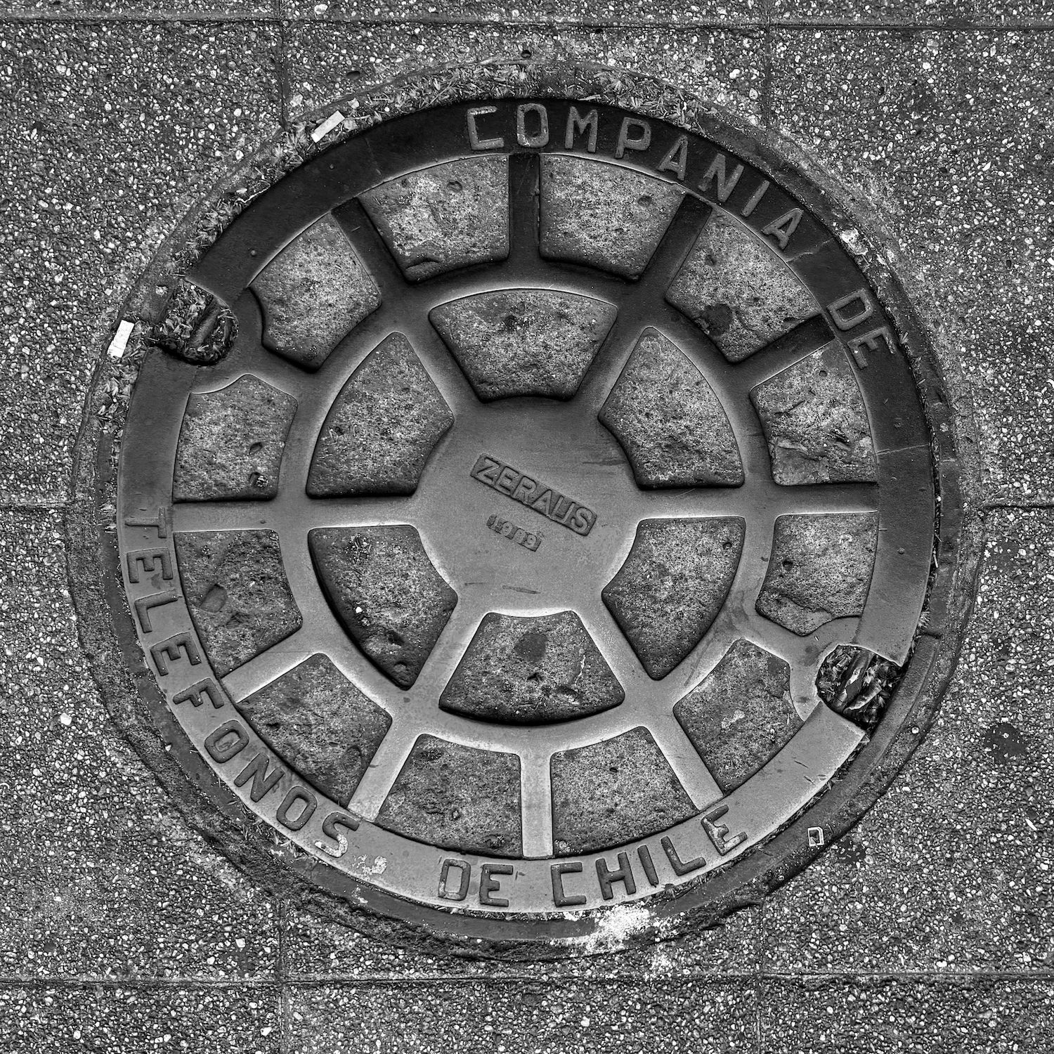 black and white image of a utility cover