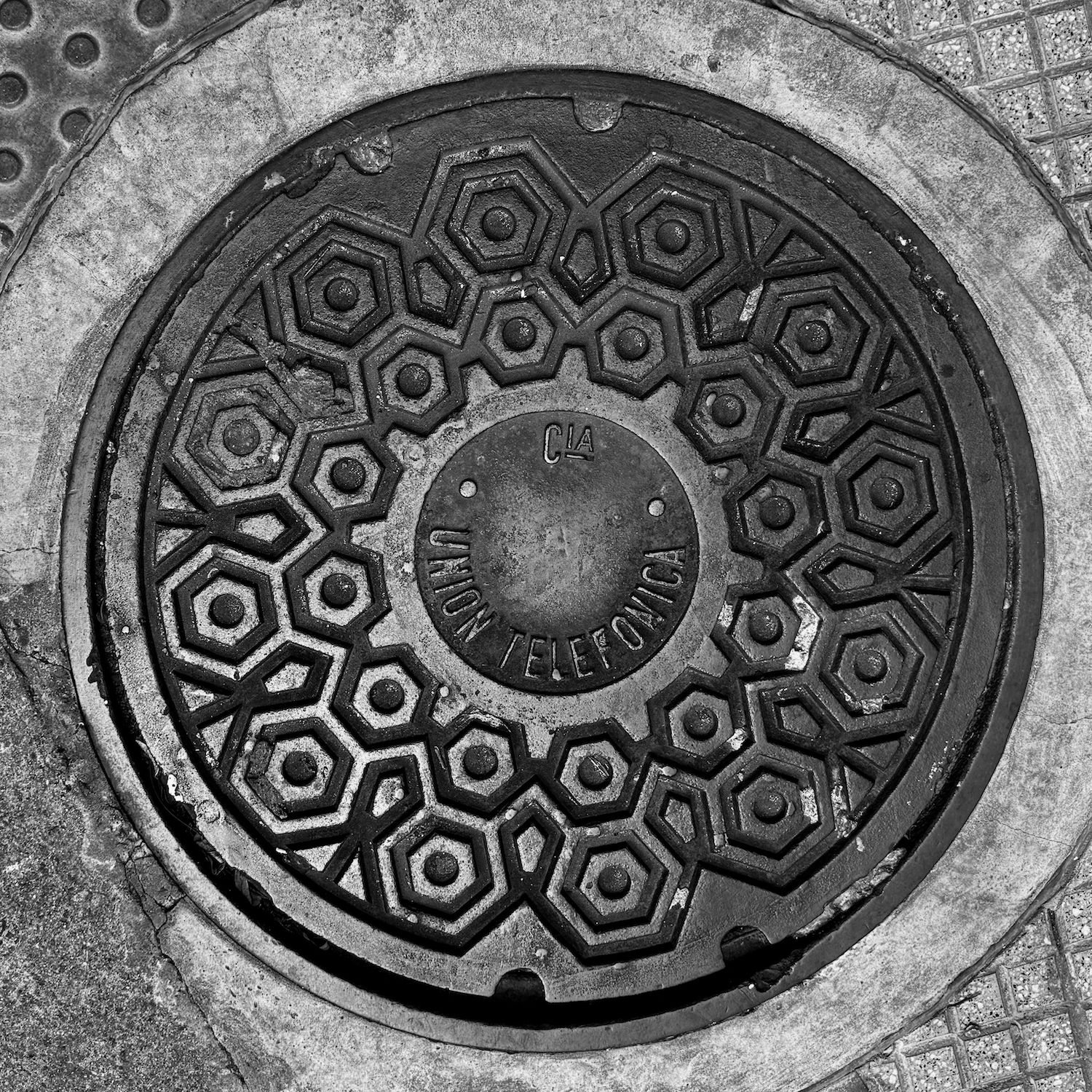 black and white image of a utility cover