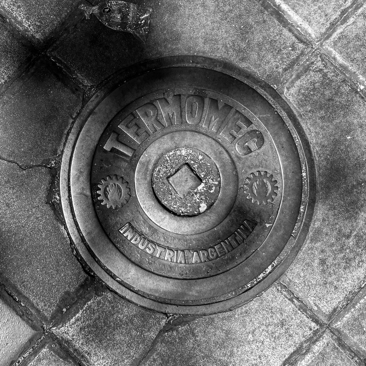 black and white image of a utility cover