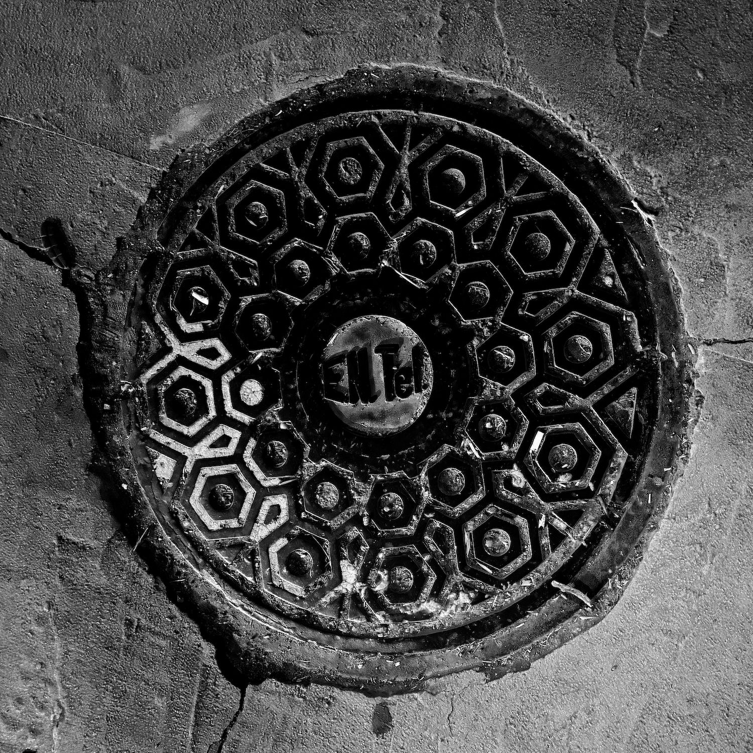 black and white image of a utility cover