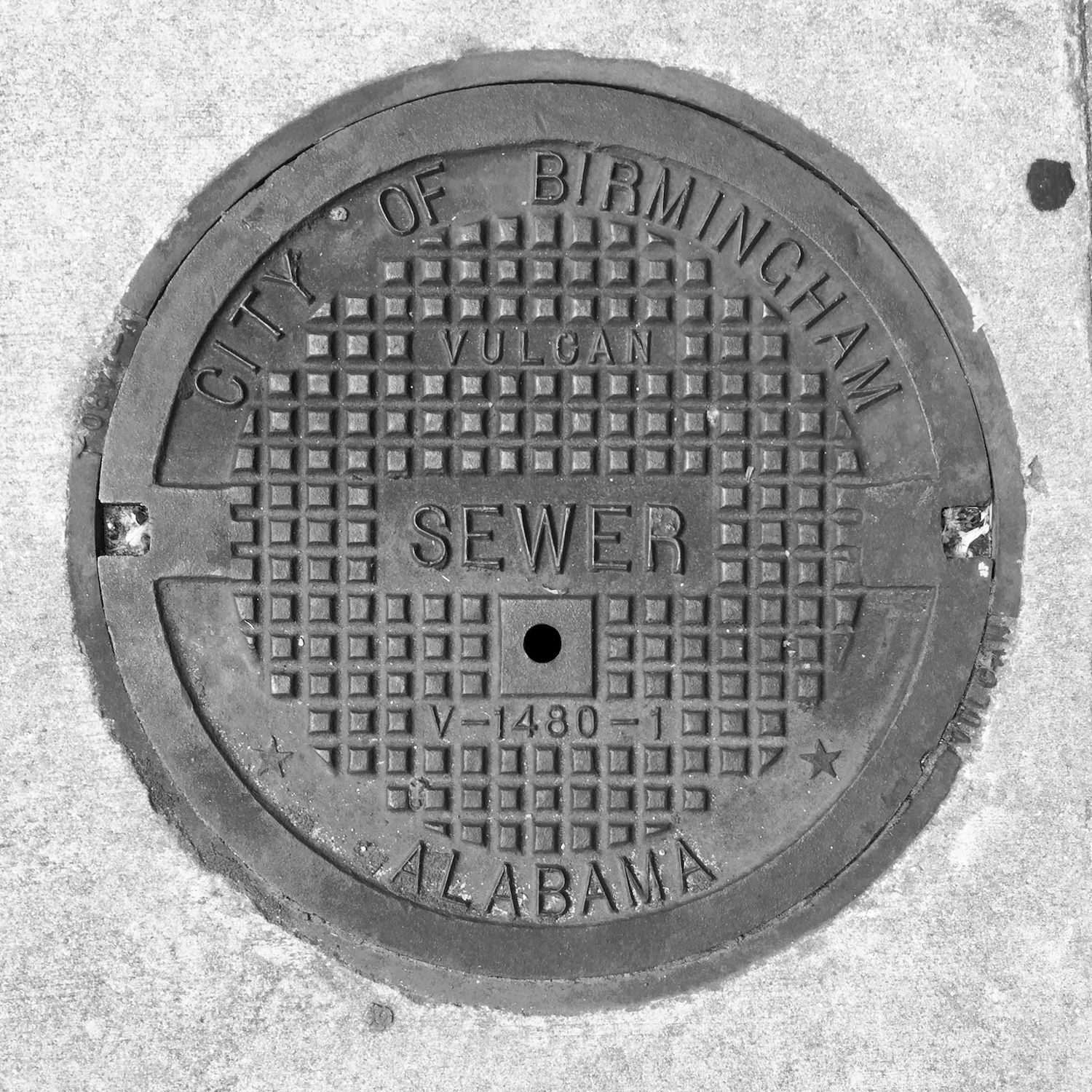black and white image of a utility cover