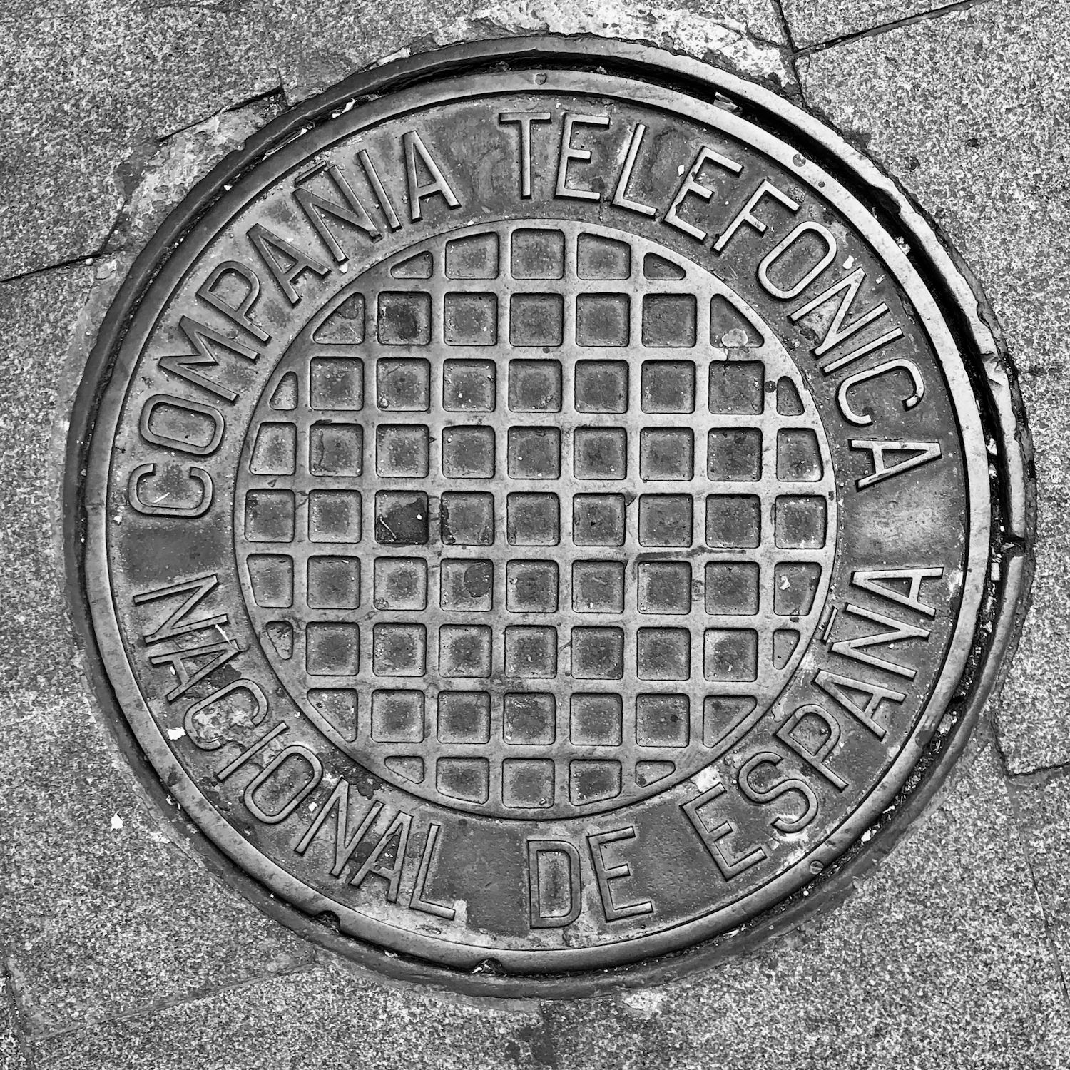 black and white image of a utility cover