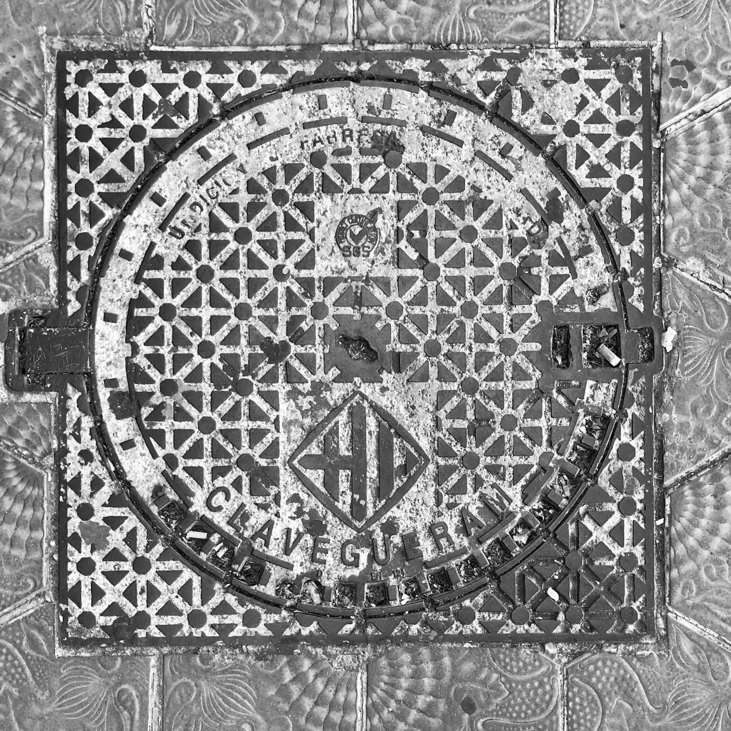 black and white image of a utility cover