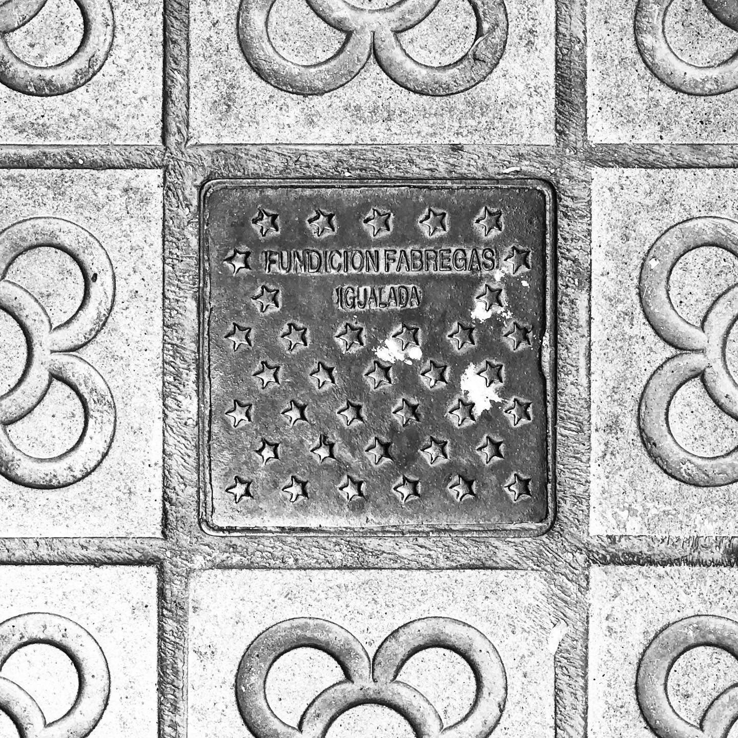 black and white image of a utility cover