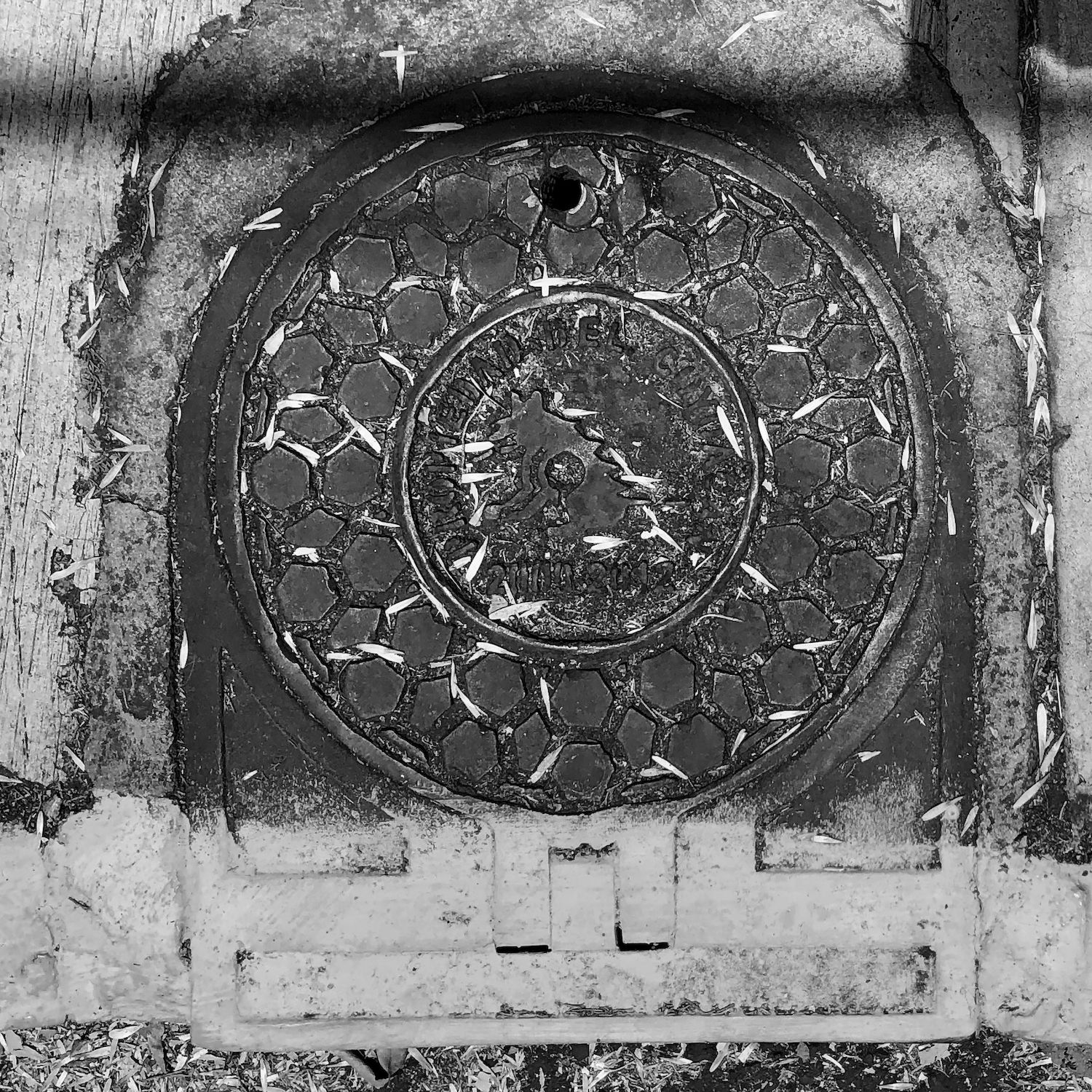 black and white image of a utility cover