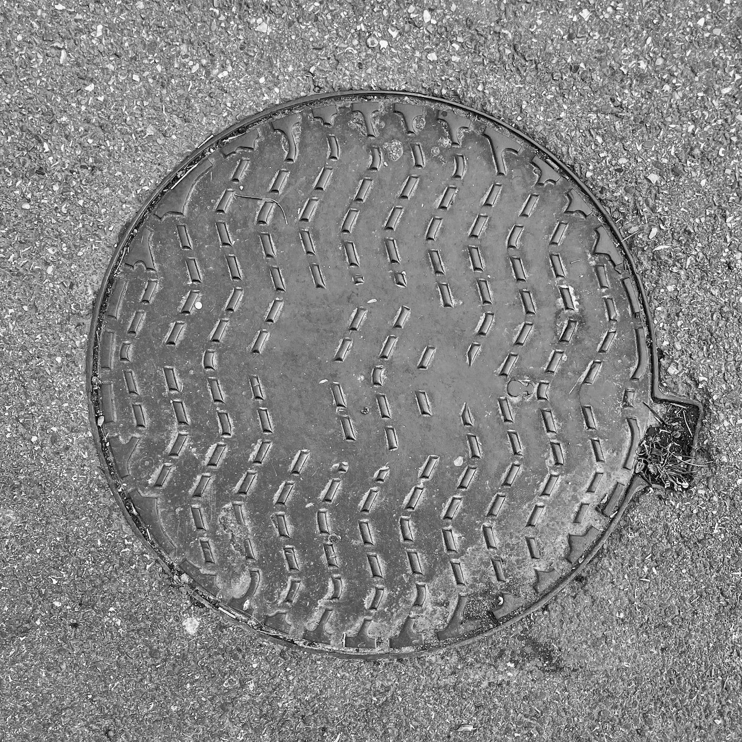 black and white image of a utility cover