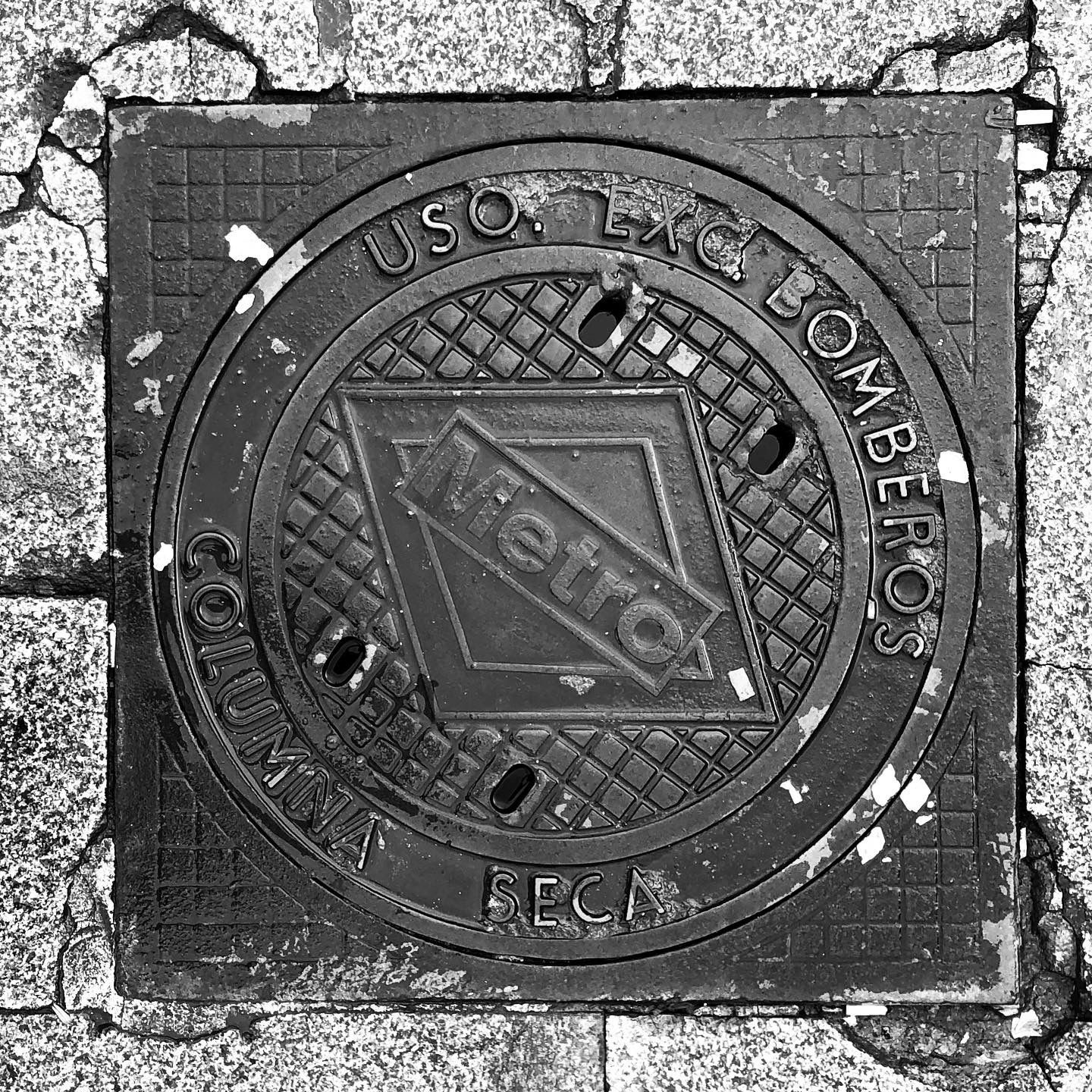 black and white image of a utility cover