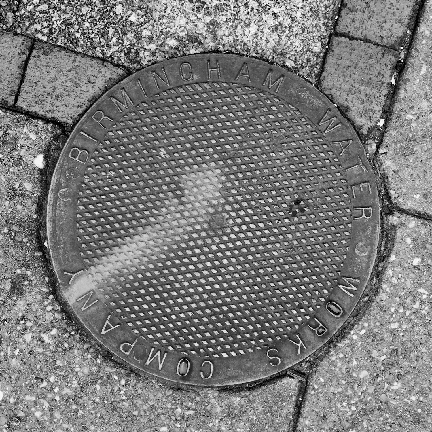 black and white image of a utility cover