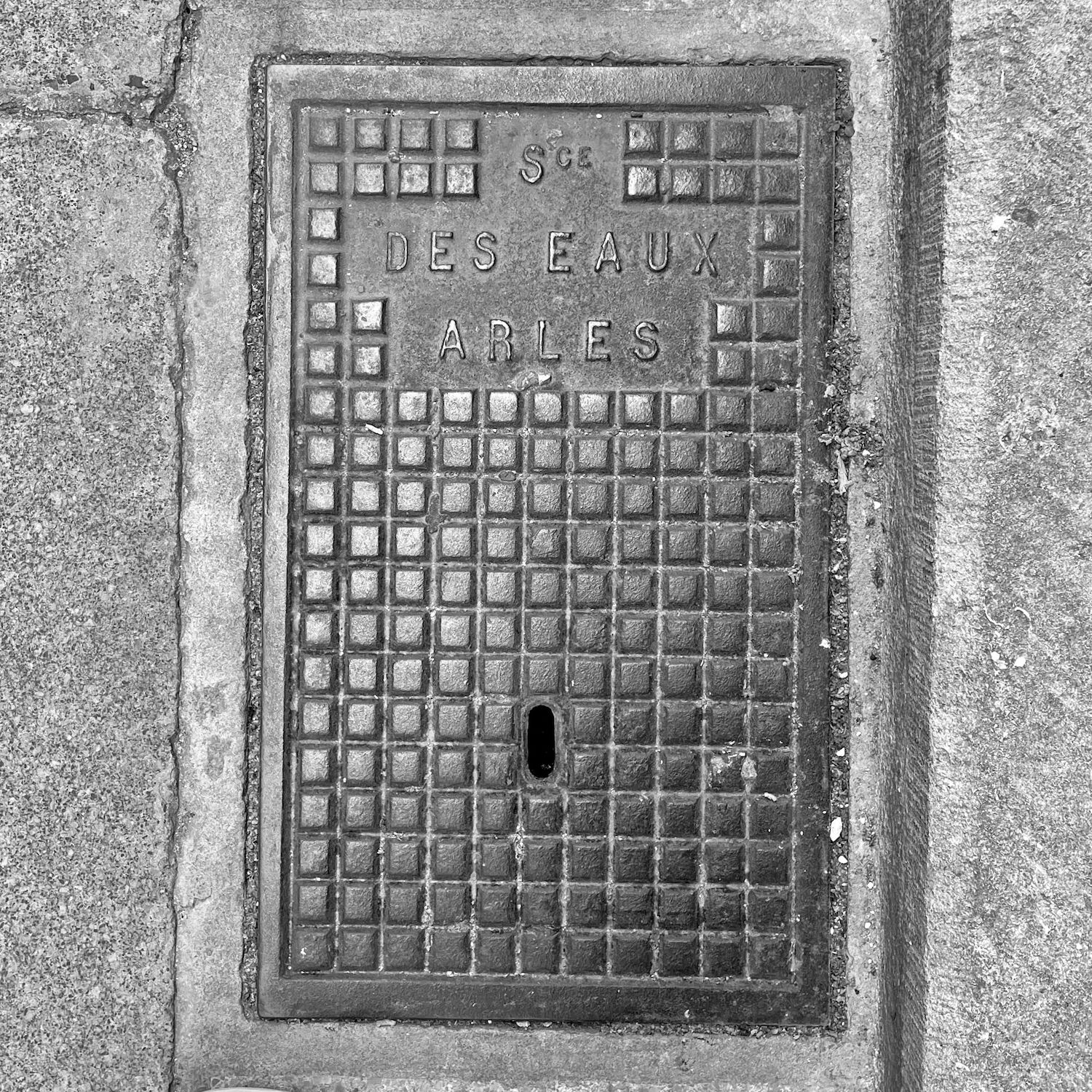 black and white image of a utility cover