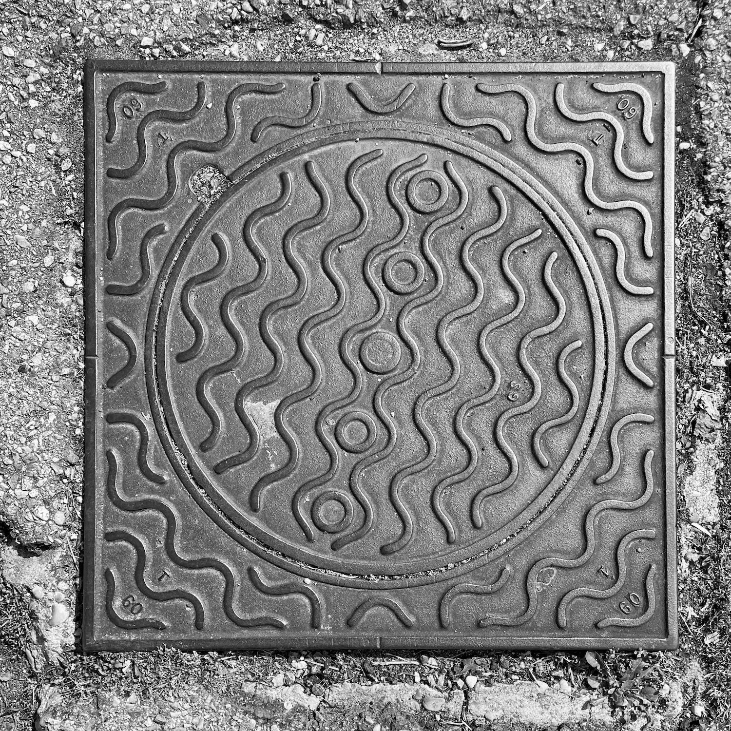 black and white image of a utility cover