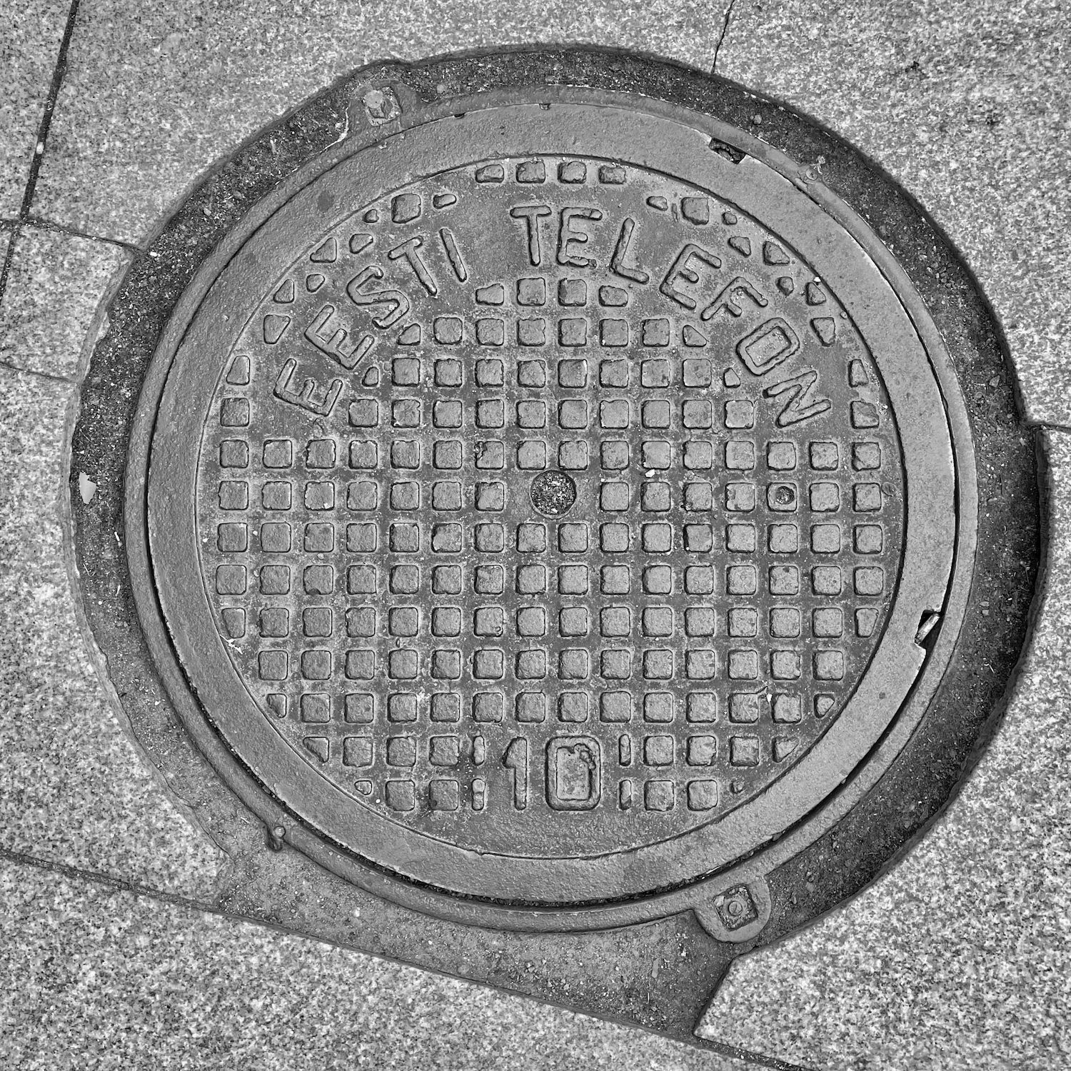 black and white image of a utility cover