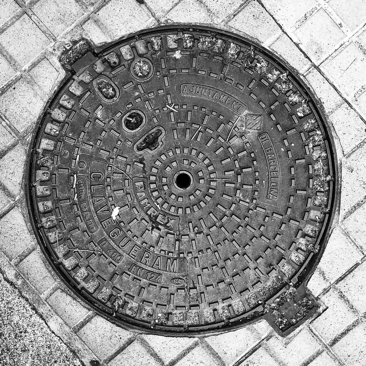 black and white image of a utility cover